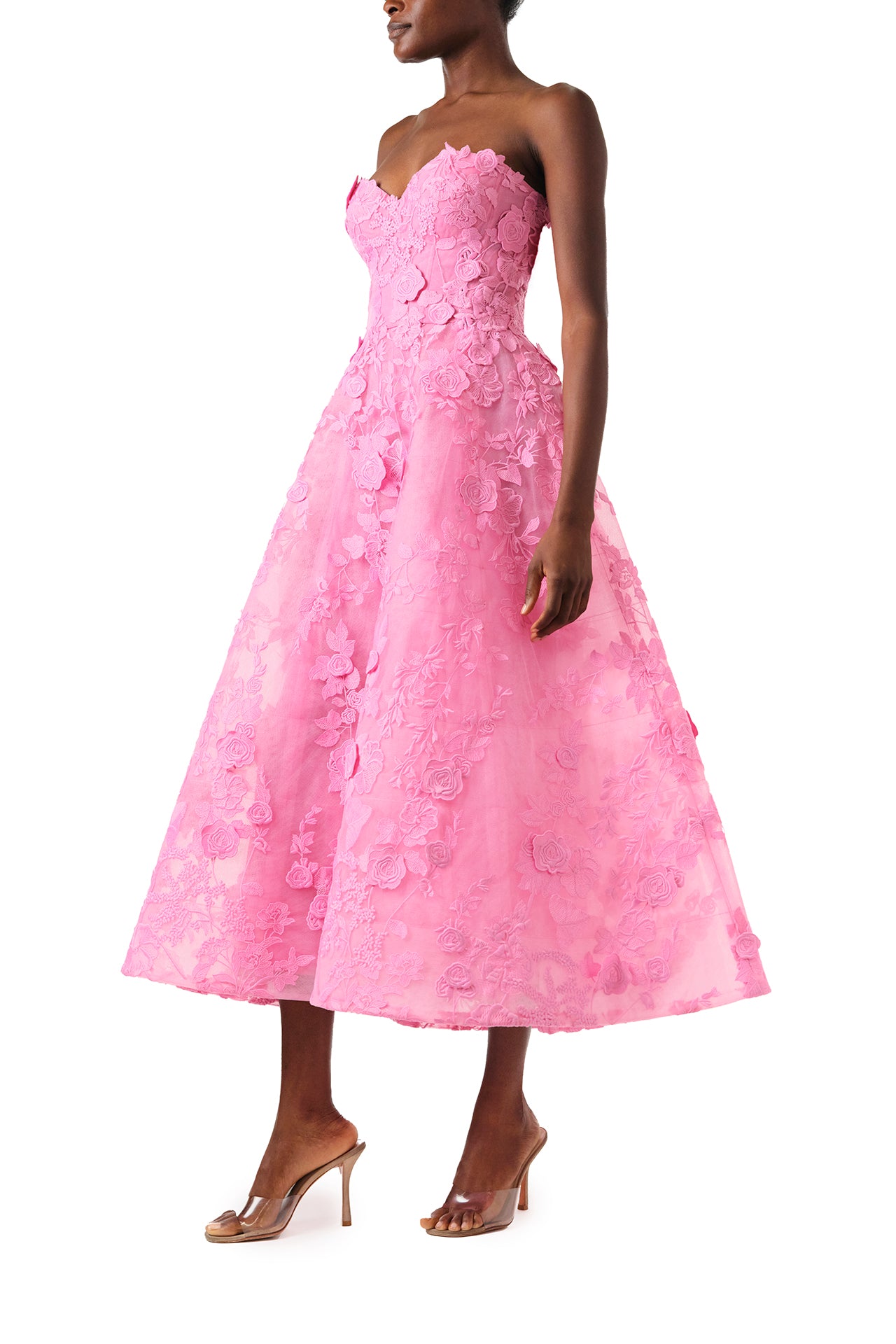 Monique Lhuillier Fall 2024 tea-length, strapless dress in pink 3D lace with full skirt and fitted sweetheart bodice - left side.