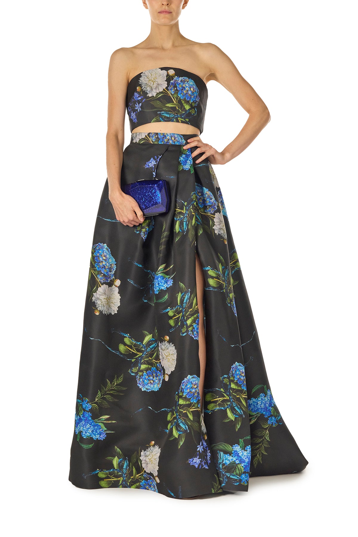 Monique Lhuillier Fall 2024 Pleated ball skirt with pockets and high front leg slit in Night Sky Hydrangea Printed Gazar - front with Dasha bag.