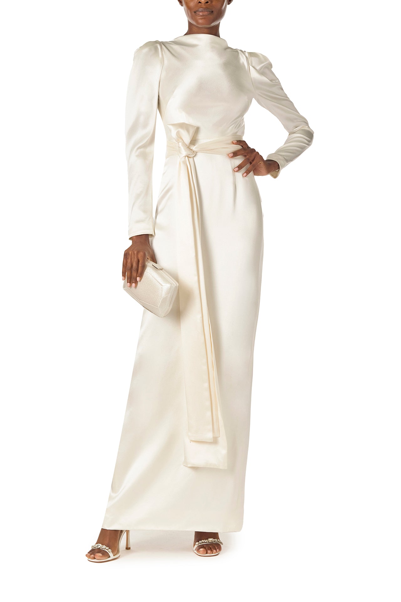 Monique Lhuillier Fall 2024 Long sleeve silk white satin gown with Bateau neckline, V-back and detached self-tie sash - front with Dasha bag.