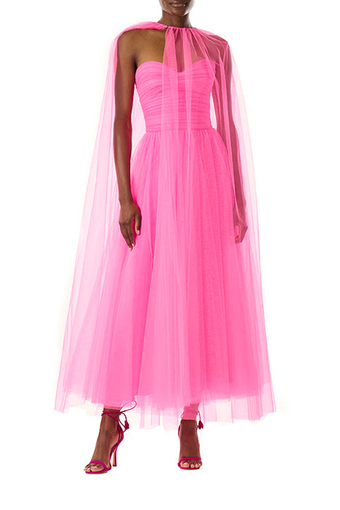 Monique Lhuillier hot pink tulle cape shown over the strapless dress with sweetheart neckline and ruched bodice.