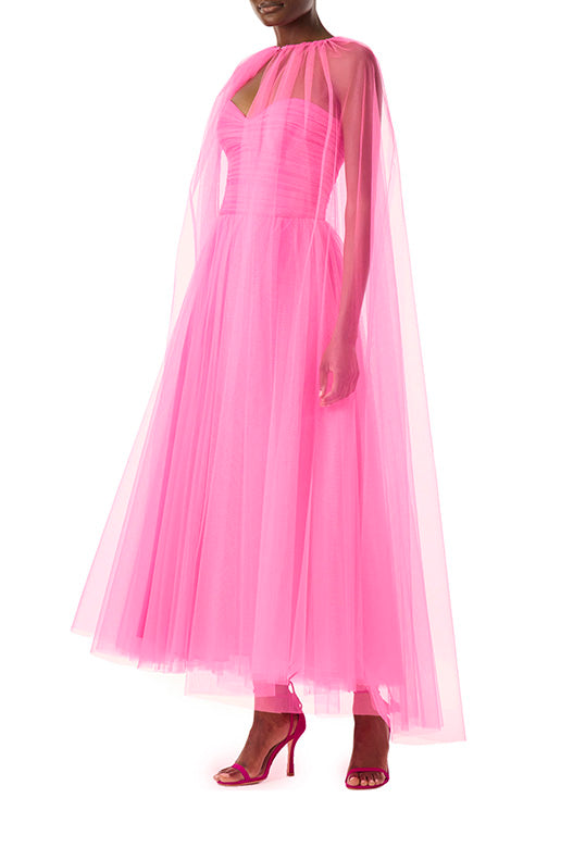 Monique Lhuillier hot pink tulle cape shown over the strapless dress with sweetheart neckline and ruched bodice.