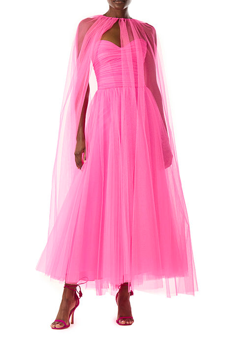 Monique Lhuillier hot pink tulle cape shown over the strapless dress with sweetheart neckline and ruched bodice.