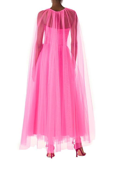Monique Lhuillier hot pink tulle cape shown over the strapless dress with sweetheart neckline and ruched bodice.