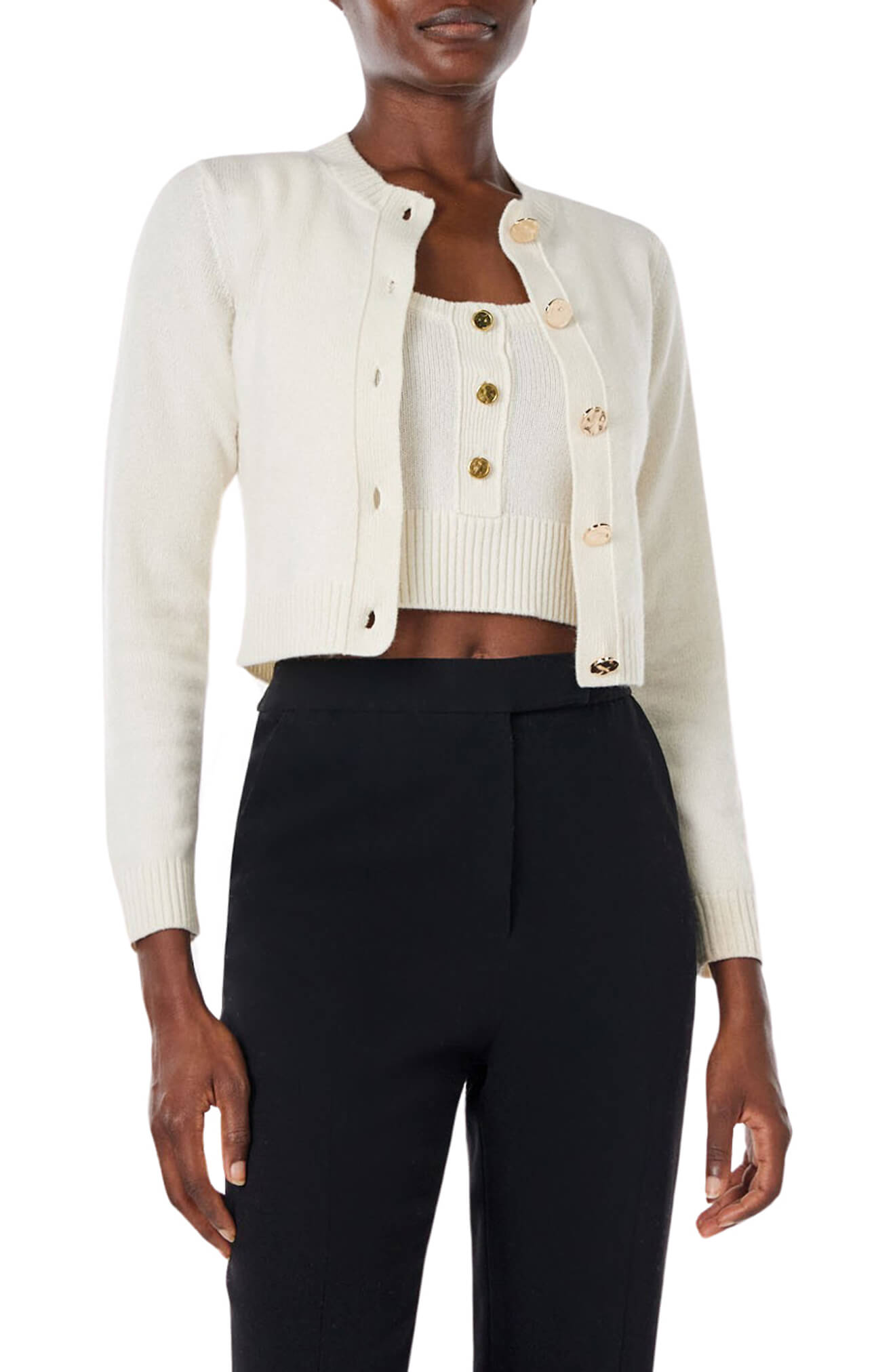 Monique Lhuillier Spring 2024 white knit cropped cardigan - front with black pants.