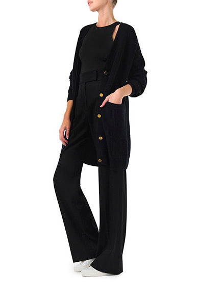 Monique Lhuillier Spring 2024 black chunky long cashmere cardigan with gold buttons - side with black pants.
