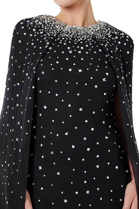 Monique Lhuillier jewel neck, cape gown in Noir chiffon and metallic embroidery.