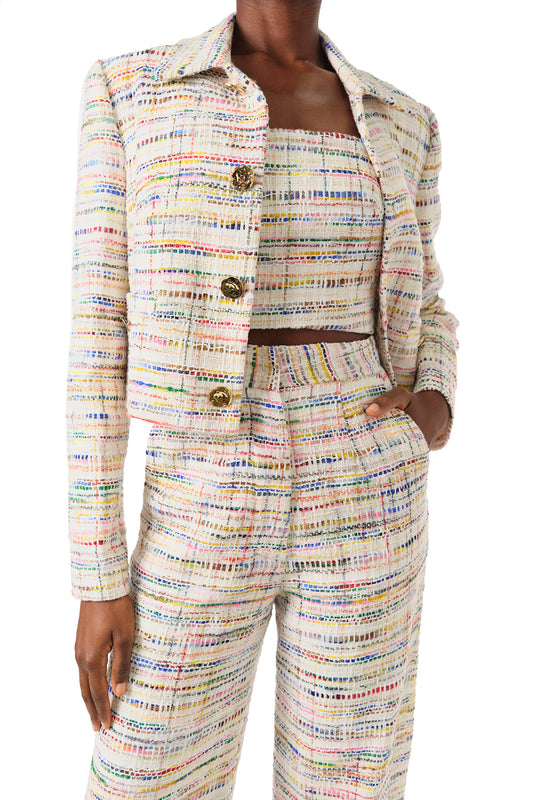Monique Lhuillier Spring 2024 silk white multi colored tweed cropped jacket shown with high waisted trousers - front detail.