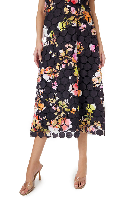 Monique Lhuillier Spring 2024 noir/multi circle lace flared midi skirt with lace scalloping detail at hem.