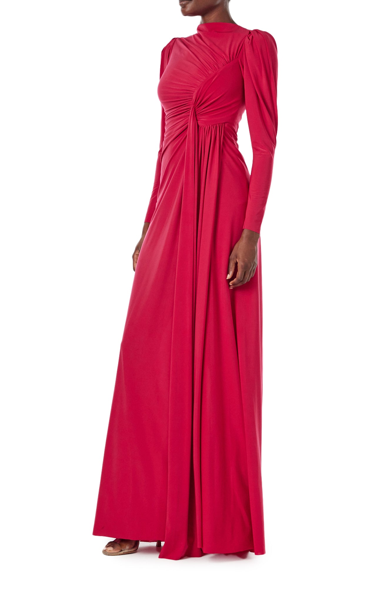 Monique Lhuillier Spring 2024 scarlet red matte jersey long sleeve, gown with draped bodice, jewel neckline and high front skirt slit - left side.