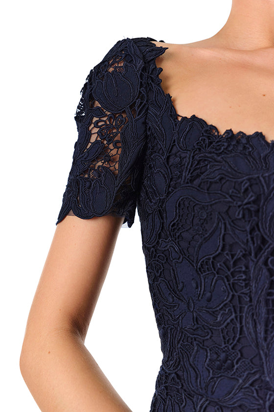 Monique Lhuillier Fall 2024 night sky colored lace sheath dress with short sleeves, scoop neckline and lace scalloped detailing - sleeve.