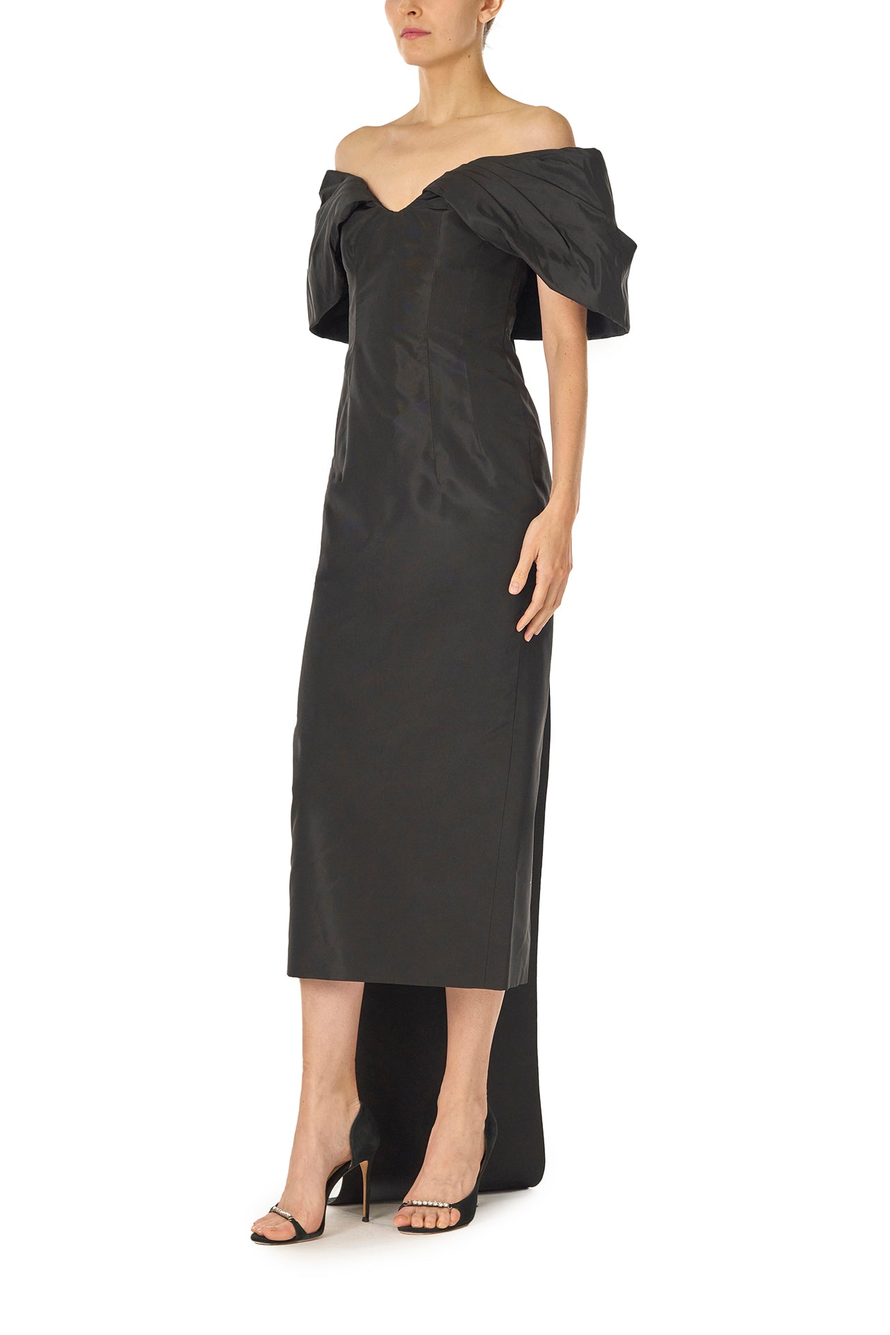 Monique Lhuillier Fall 2024 Off-the-shoulder tea length column dress with draped neckline and train in noir silk faille - left side.