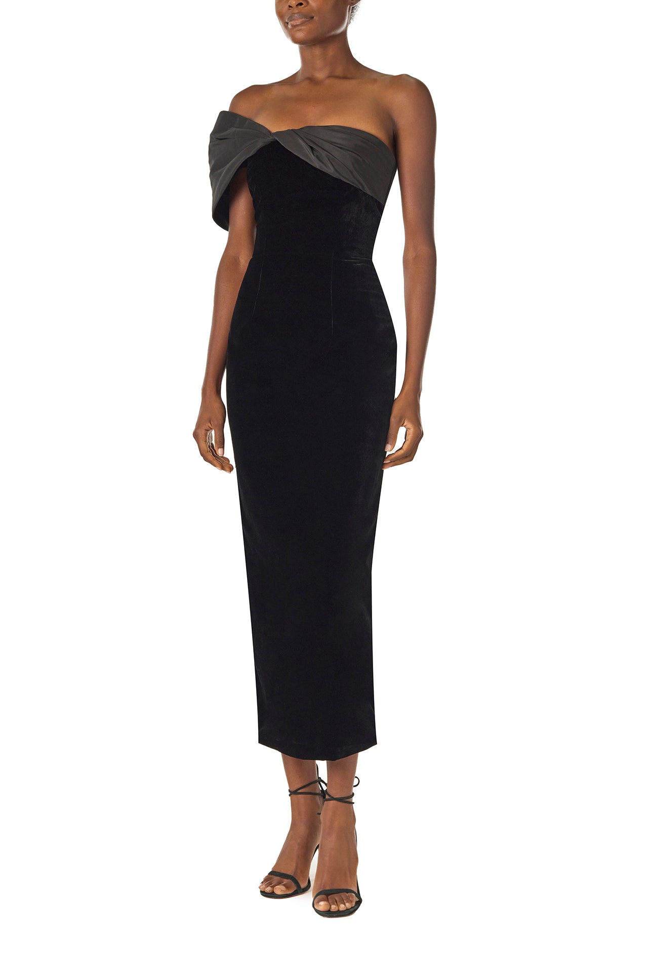 Monique Lhuillier Fall 2024 asymmetric, off the shoulder sheath dress in noir silk faille and velvet with draped twist detail at neckline - left side.
