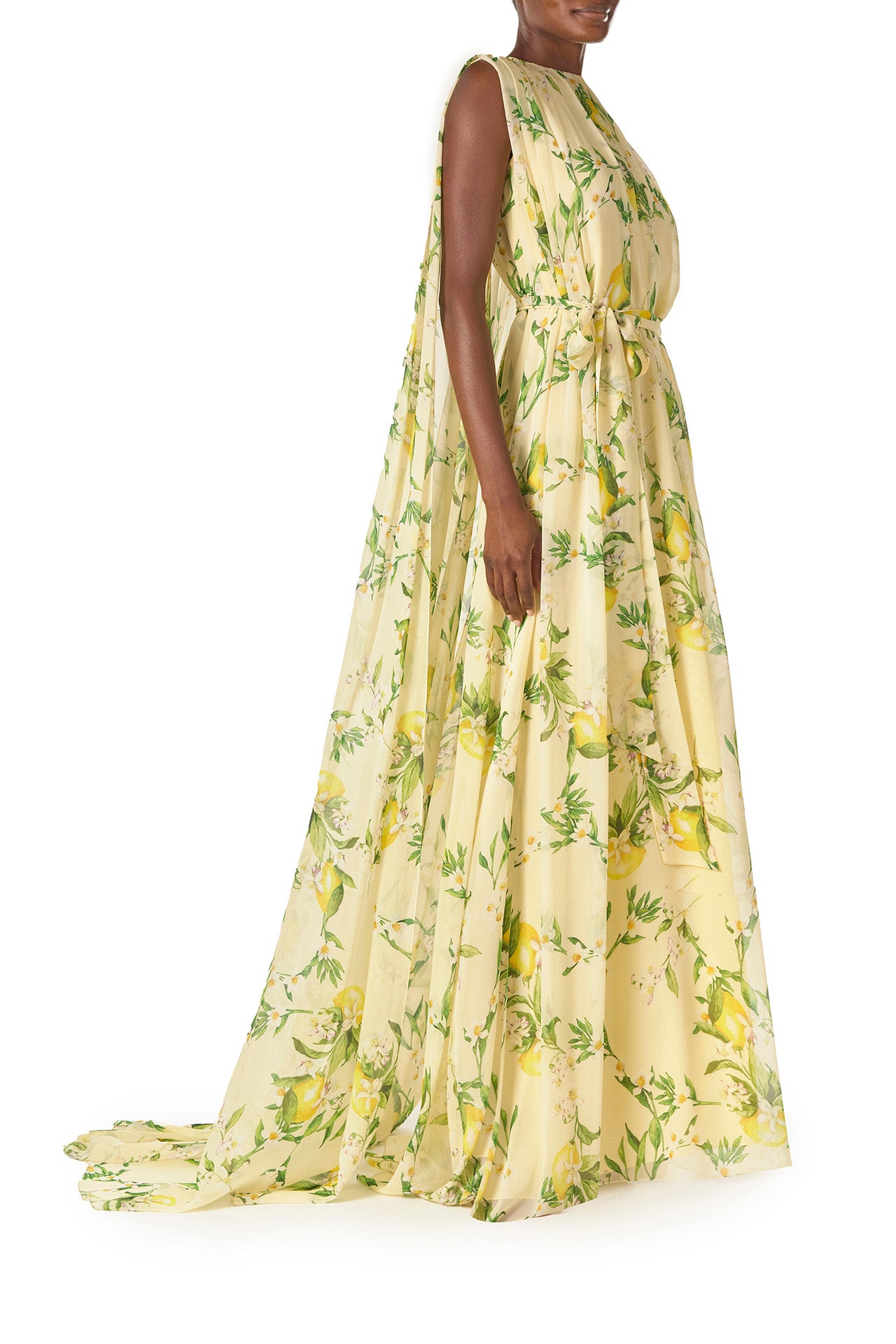 Monique Lhuillier Spring 2025 Lemon printed georgette sleeveless draped gown with integral cape - side.