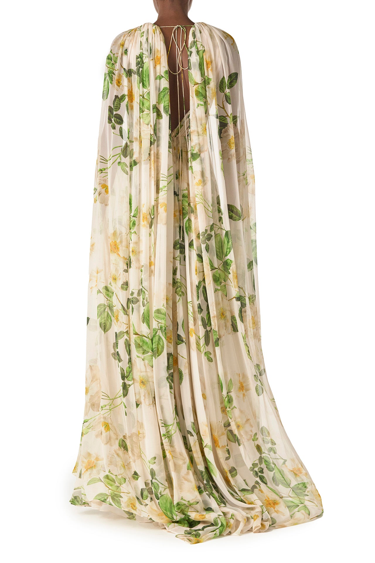 Monique Lhuillier Spring 2025 Draped, v-neck gown in Rose Printed Chiffon with low back and flowing, integral cape - back.