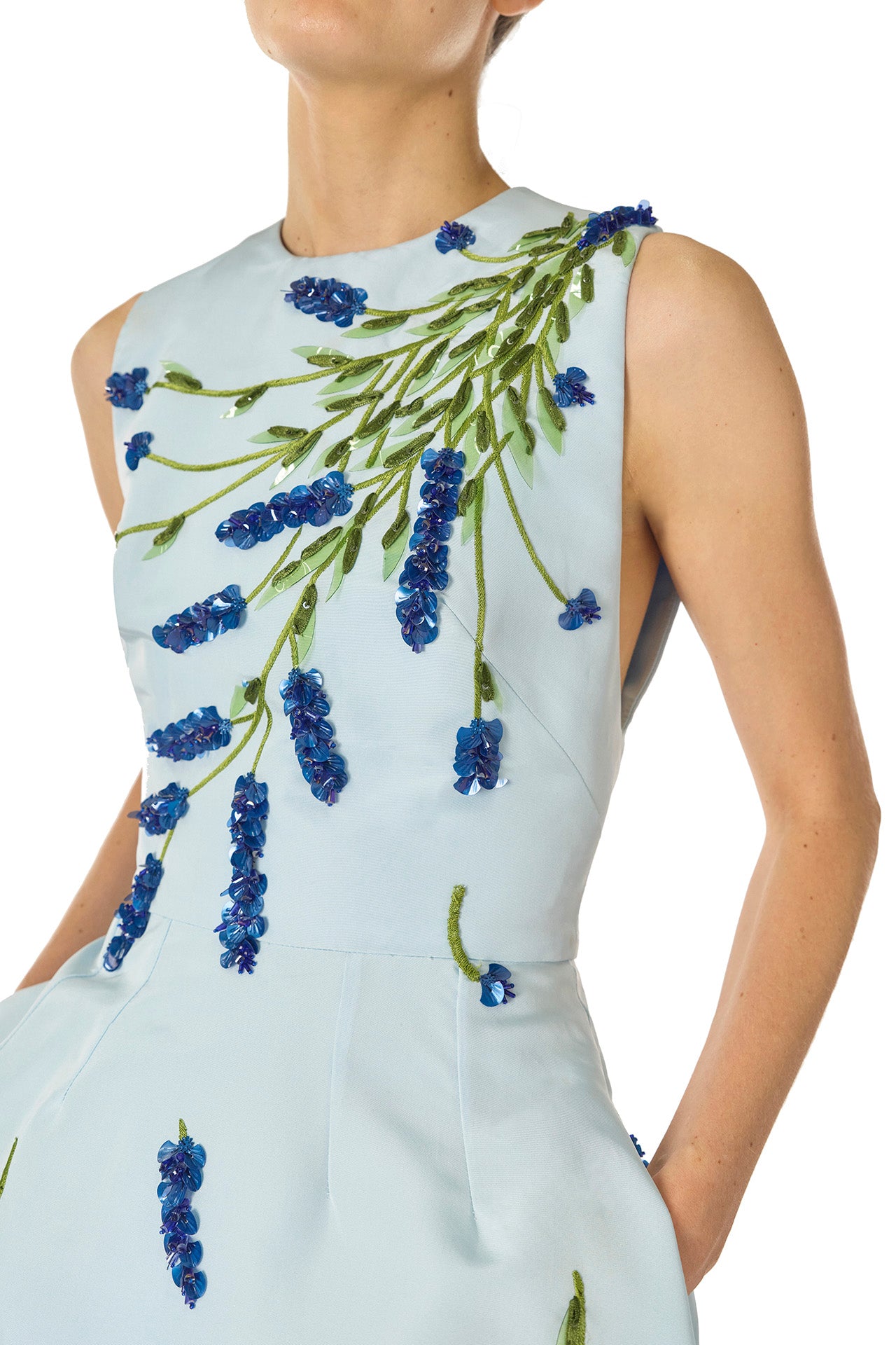 Monique Lhuillier Spring 2025 Sleeveless, tea-length dress with pockets in Powder Blue faille with Lavender-patterned embroidery - fabric detail.