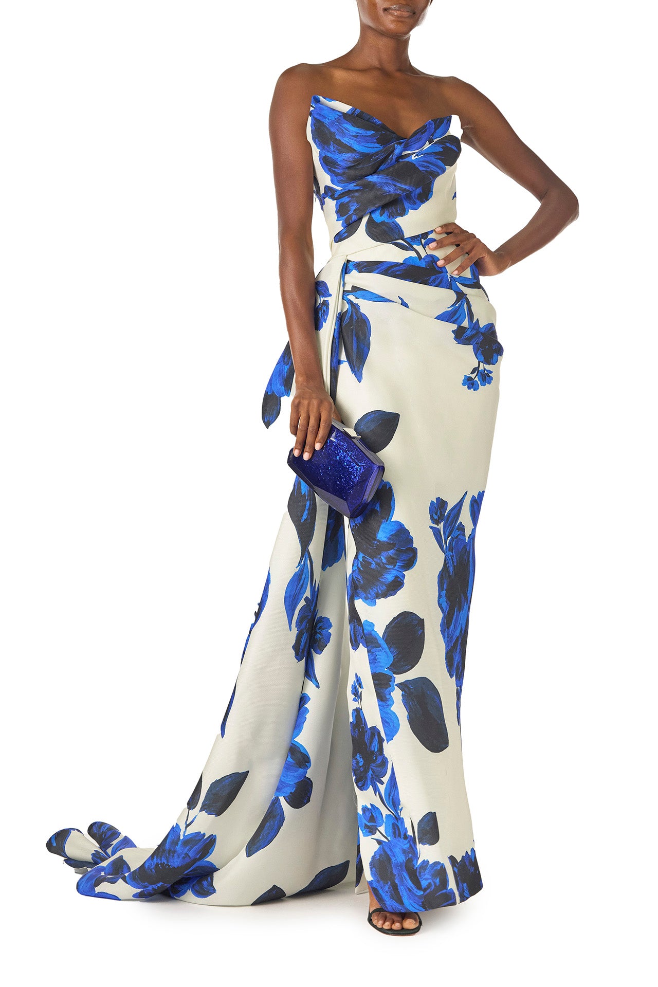 Lucite faceted minaudière with silver metal clasp at top in Blue- on model in silk white blue floral gown.