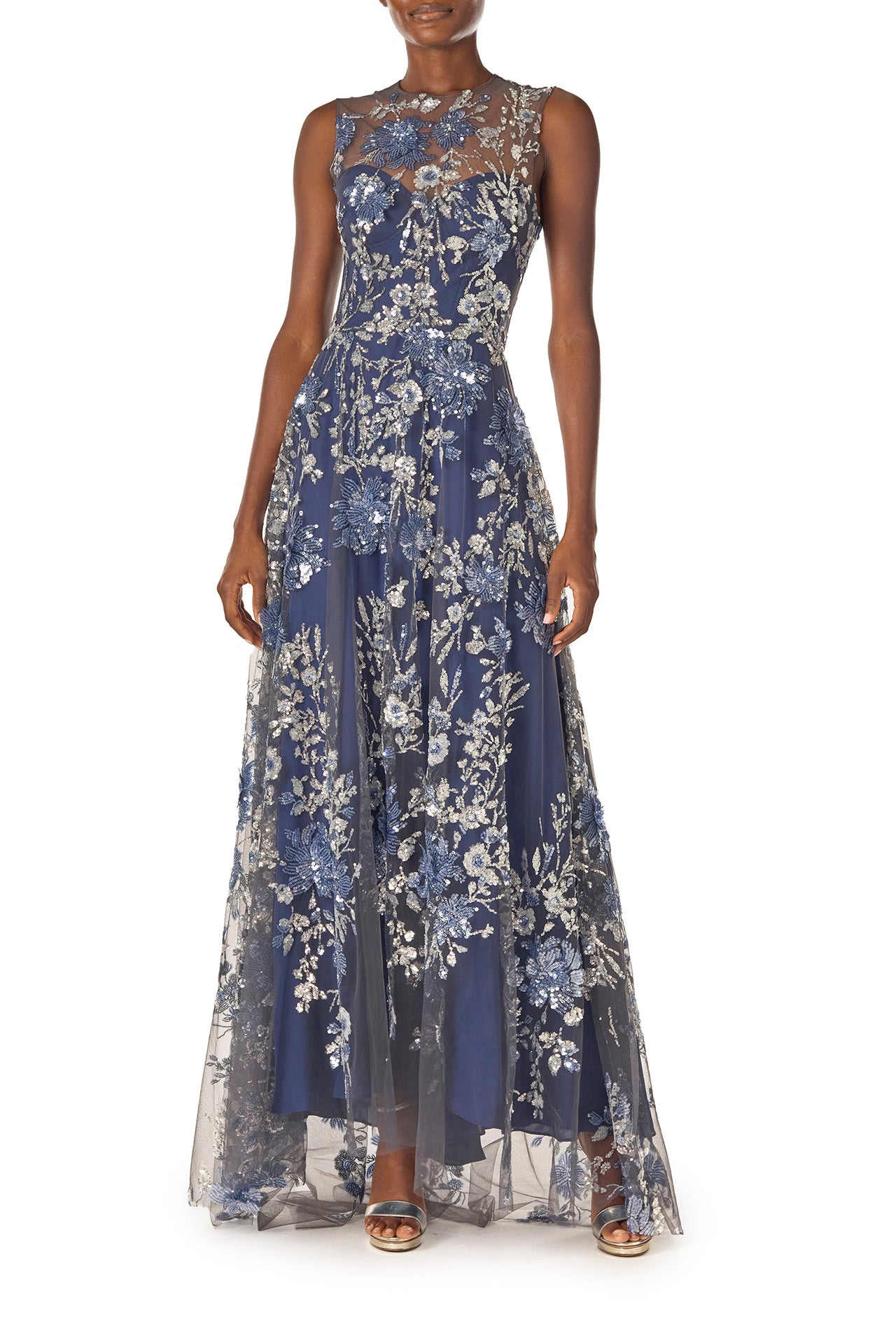 Monique Lhuillier sleeveless, sequin tulle gown with illusion neckline and slight high-low hem in navy multi colors - front.