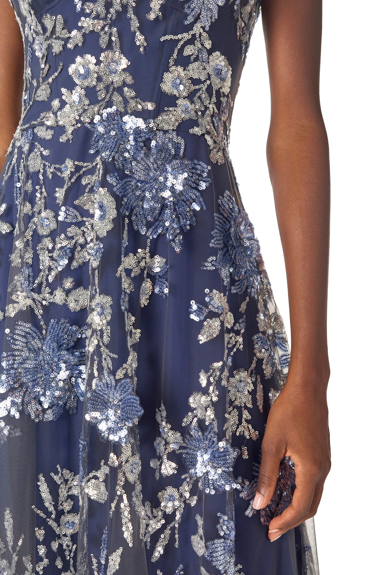 Monique Lhuillier sleeveless, sequin tulle gown with illusion neckline and slight high-low hem in navy multi colors - fabric detail.