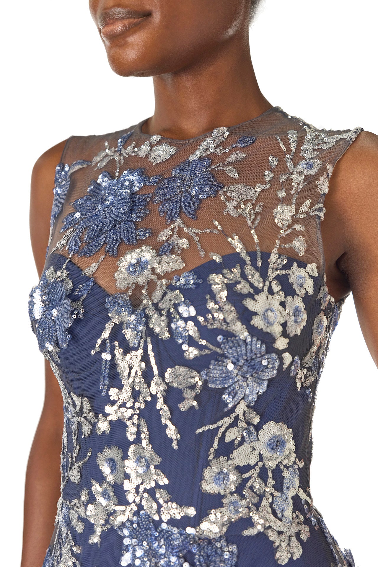 Monique Lhuillier sleeveless, sequin tulle gown with illusion neckline and slight high-low hem in navy multi colors - illusion neckline.