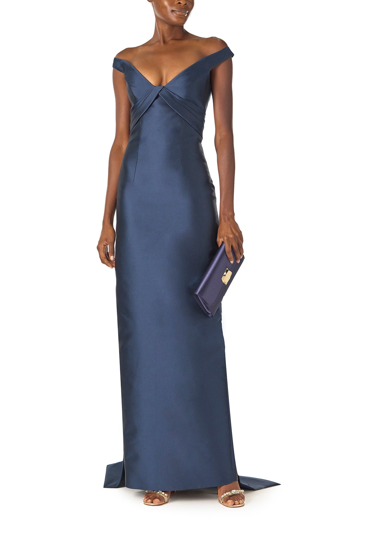 Monique Lhuillier Spring 2025 Off the shoulder gown with draped, low cut V-neckline and with integral draped ties down the back in Lapis Mikado - front with Delphine clutch.