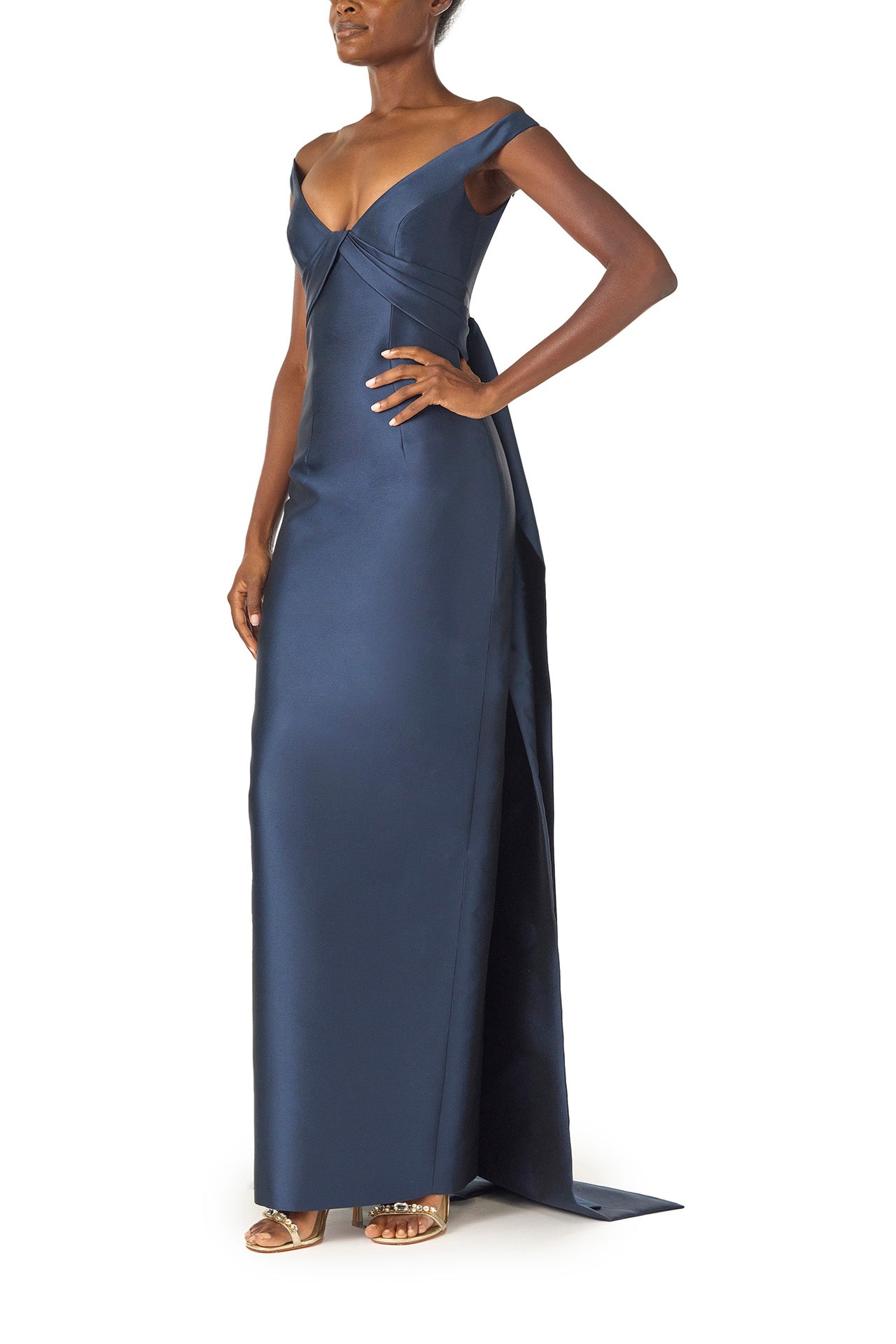 Monique Lhuillier Spring 2025 Off the shoulder gown with draped, low cut V-neckline and with integral draped ties down the back in Lapis Mikado - left side.