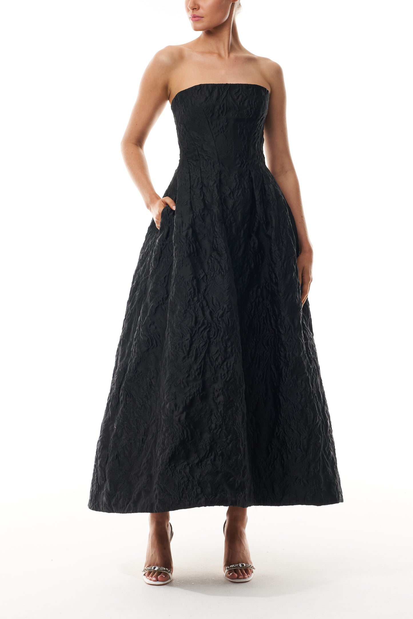 Monique Lhuillier Fall 2025 strapless midi-length dress with pockets in noir floral jacquard - front.