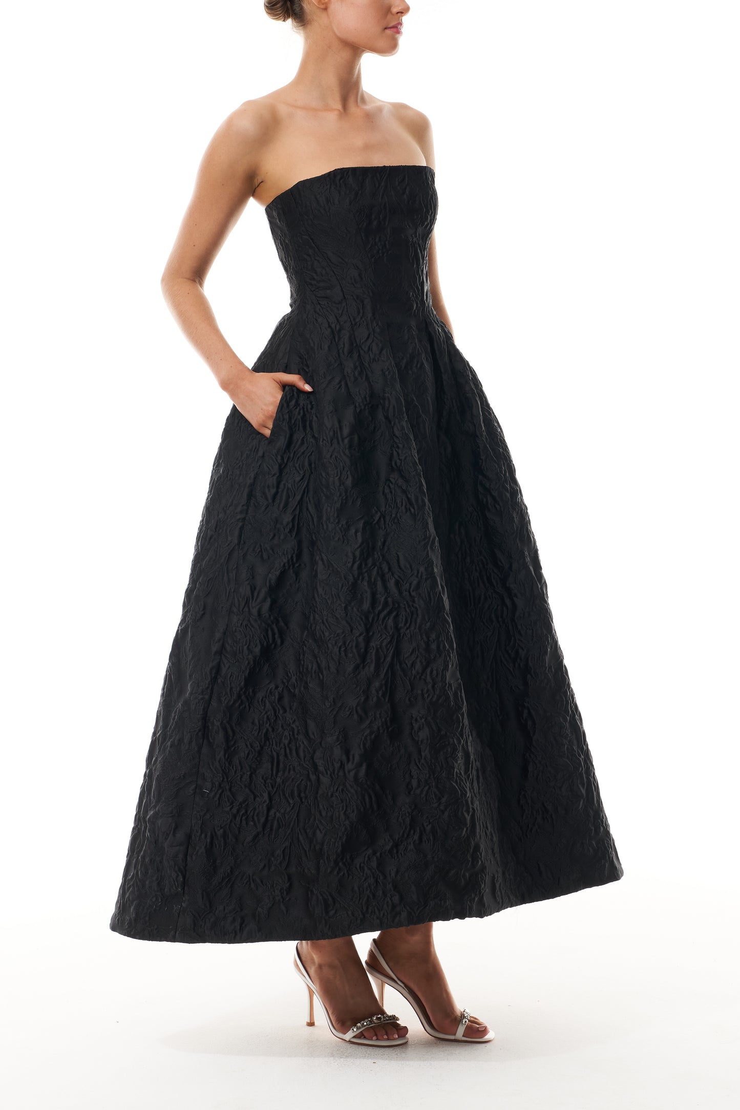 Monique Lhuillier Fall 2025 strapless midi-length dress with pockets in noir floral jacquard - side.