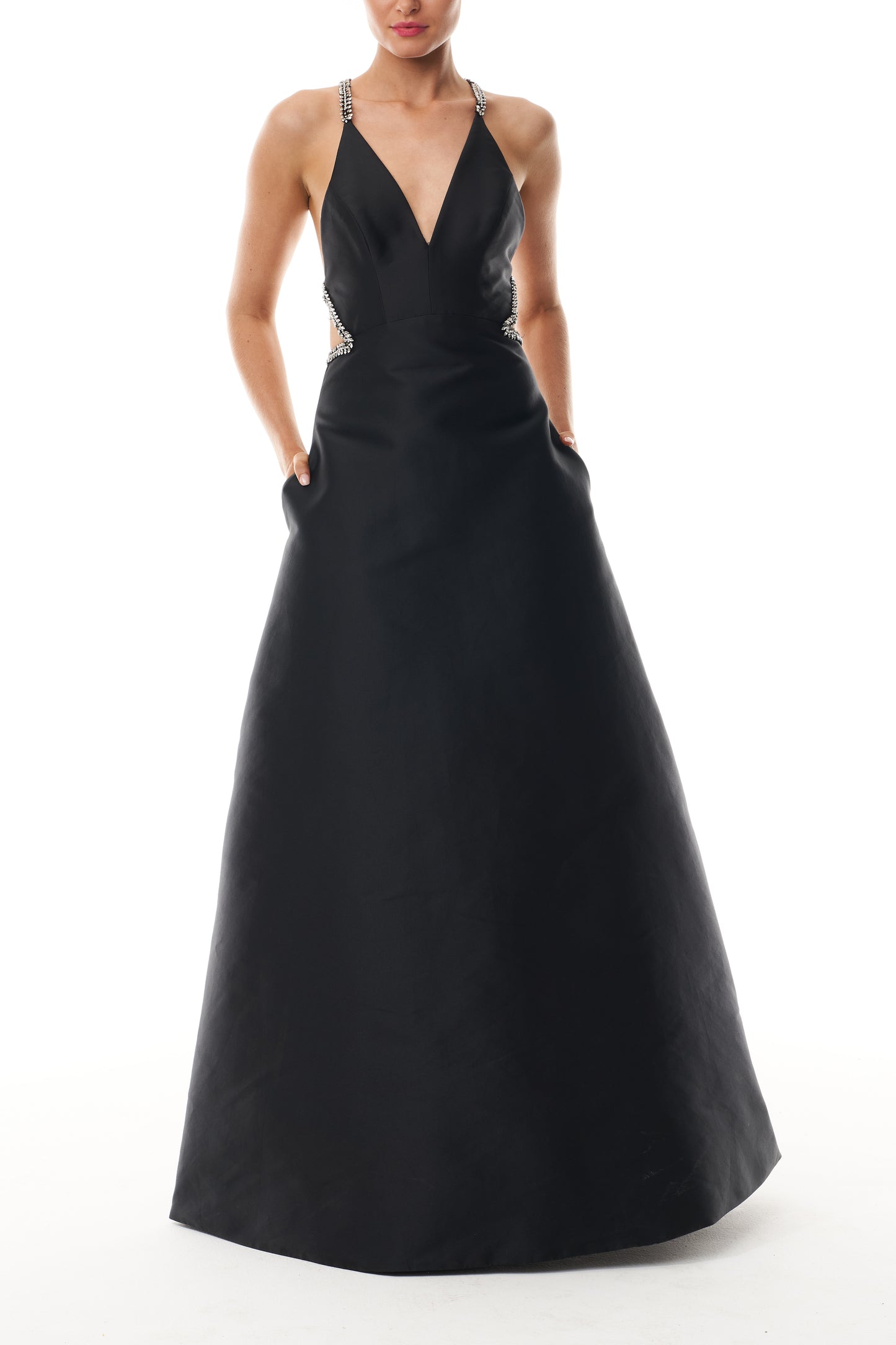 Monique Lhuillier Fall 2025 floor length ball gown with cut-out details and crystal embroidered piping in noir mikado - front.
