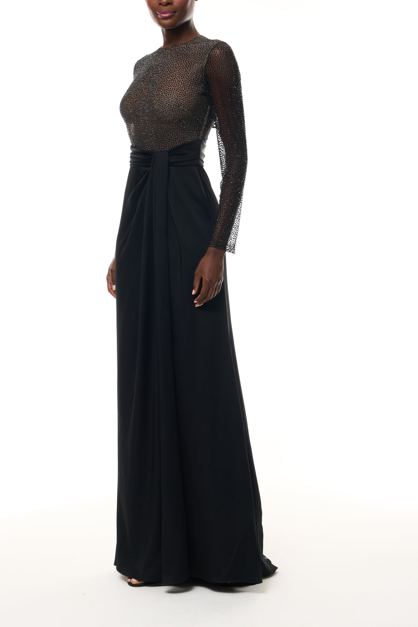 Monique Lhuillier Fall 2025 RTW Noir Long Sleeve Hotfix gown with embellished bodice and front slit - side.