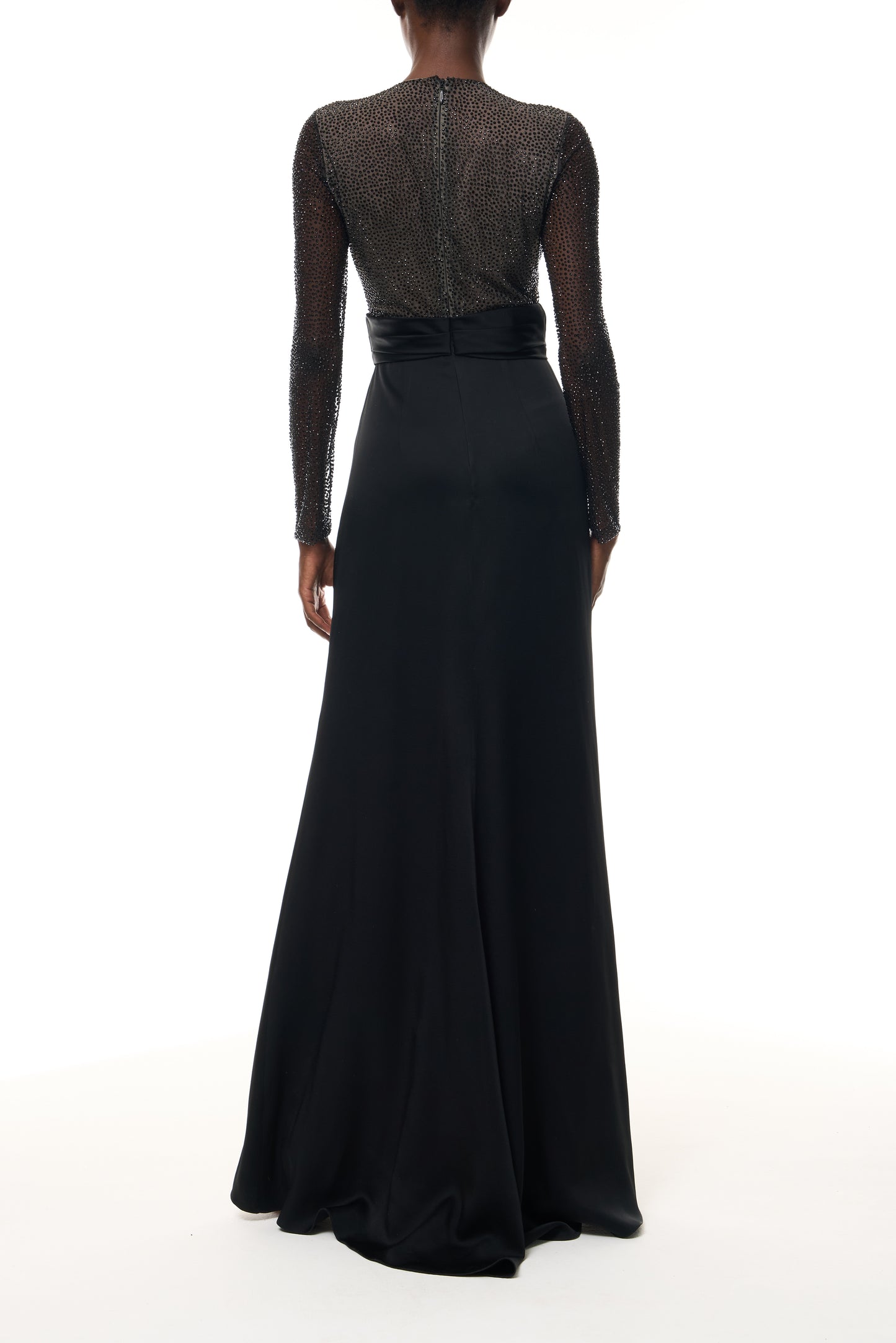 Monique Lhuillier Fall 2025 RTW Noir Long Sleeve Hotfix gown with embellished bodice and front slit - back.