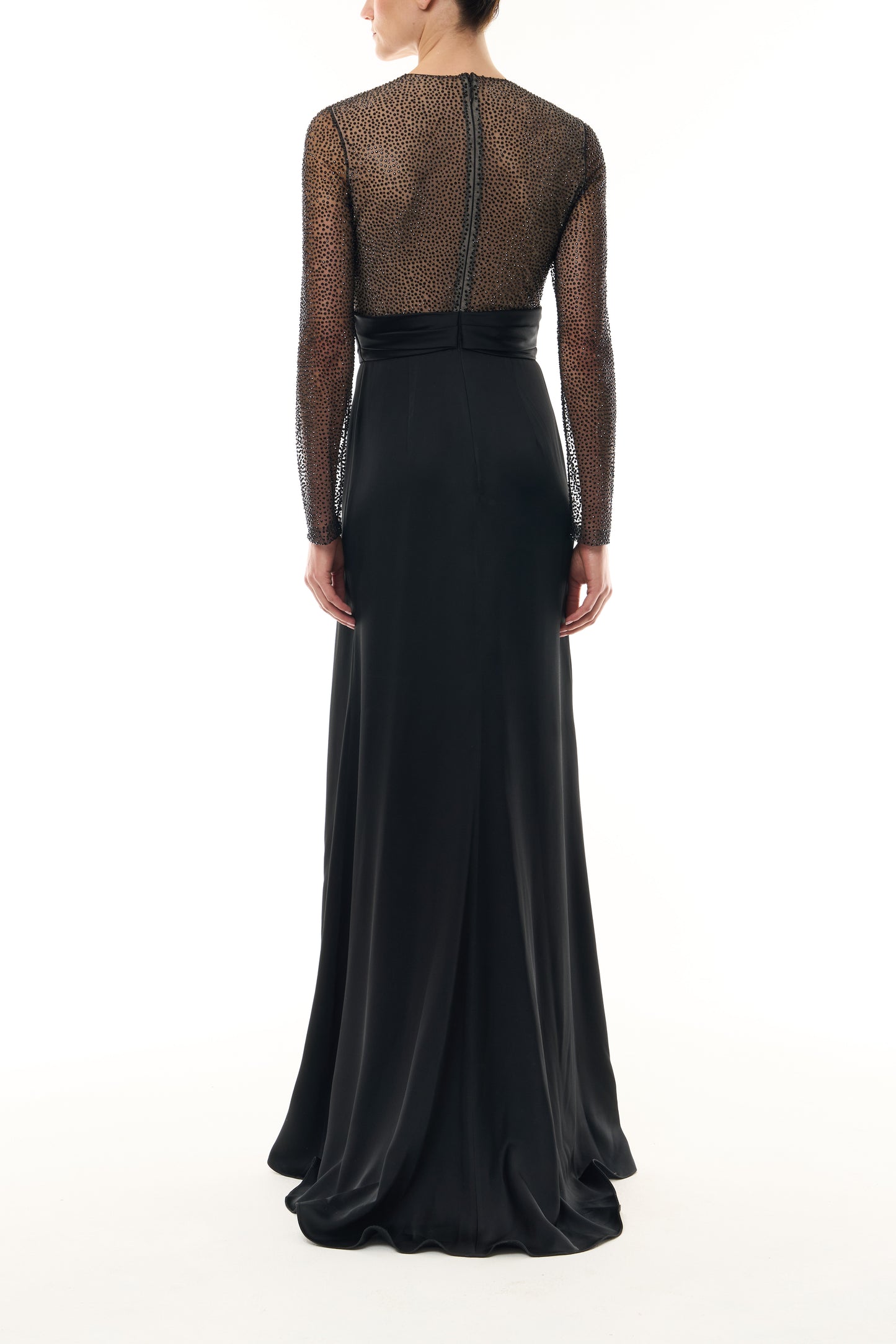 Monique Lhuillier Fall 2025 RTW Noir Long Sleeve Hotfix gown with embellished bodice and front slit - back.