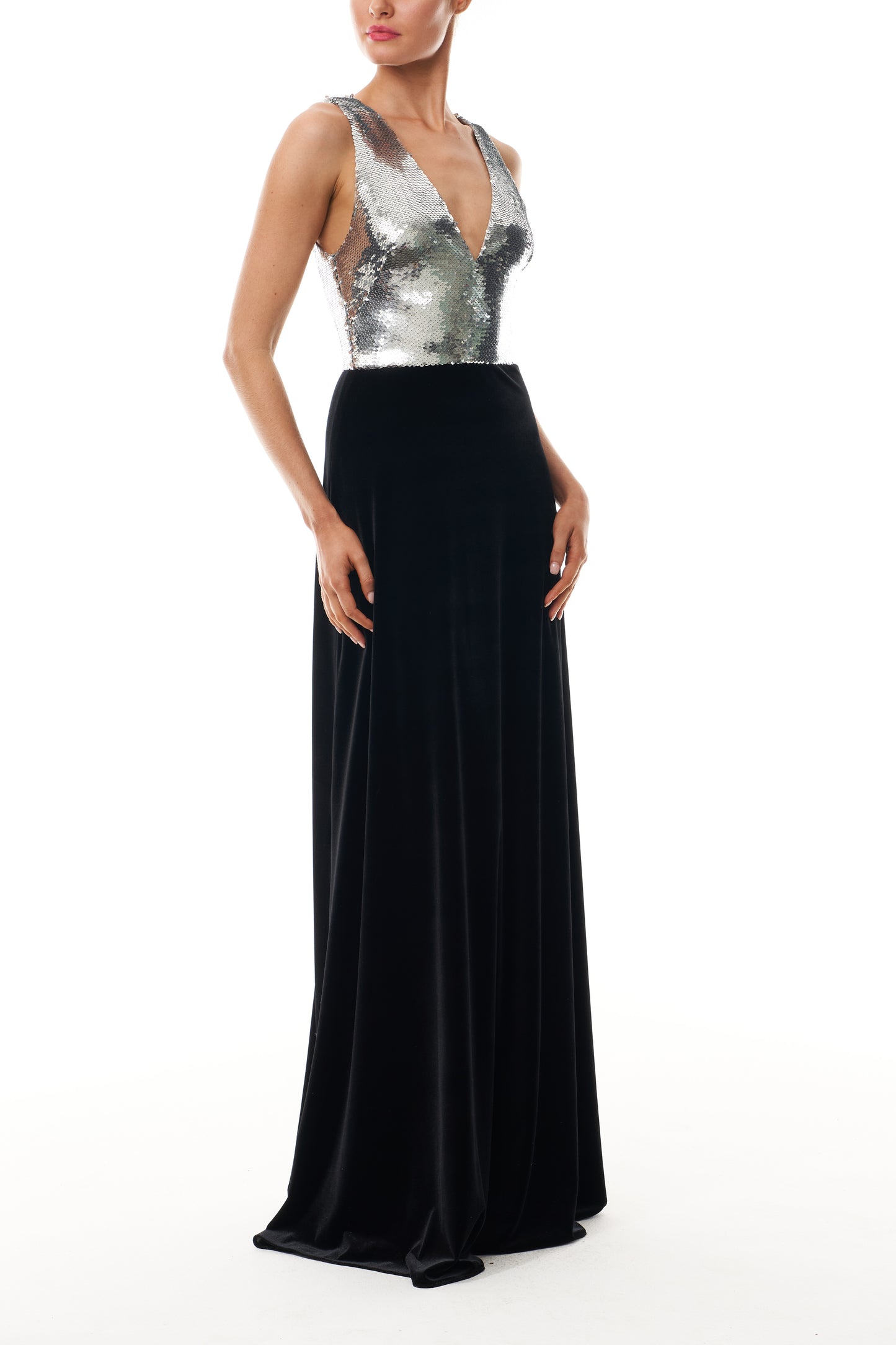 Monique Lhuillier Fall 2025 v-neck gown with silver sequin bodice and noir velvet skirt - side.