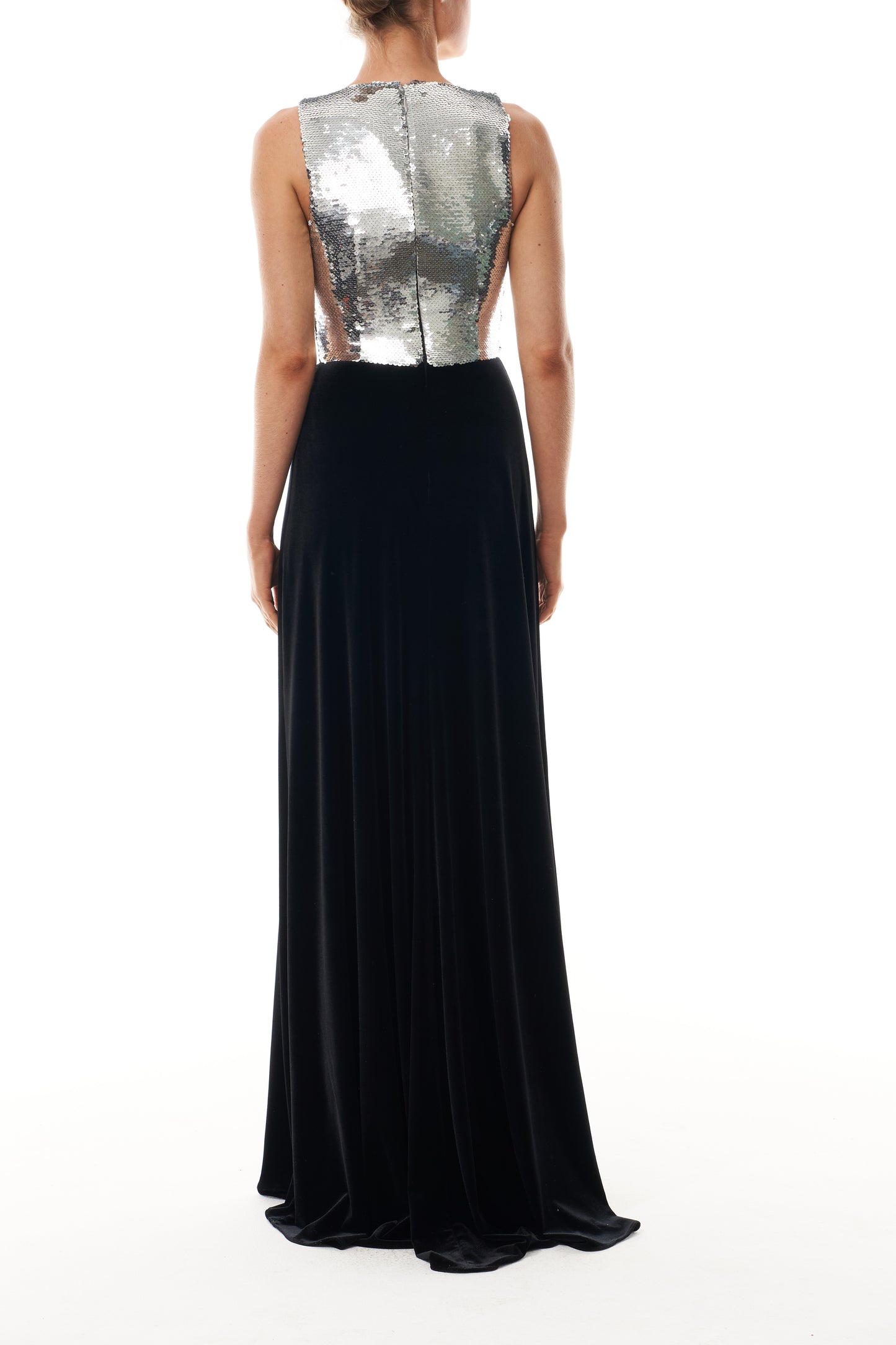 Monique Lhuillier Fall 2025 v-neck gown with silver sequin bodice and noir velvet skirt - back.