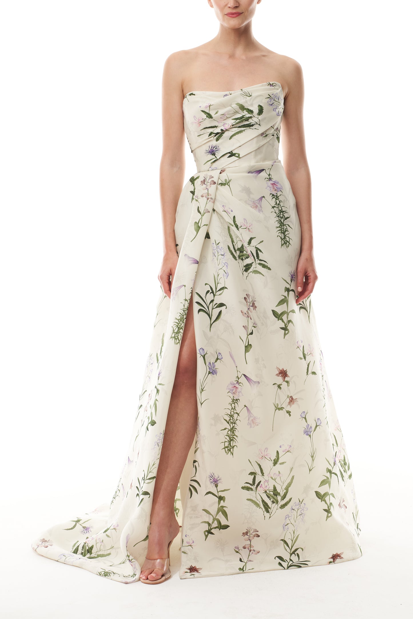 Monique Lhuillier Fall 2025 strapless, floor length gown with draped bodice and high leg slit in ivory floral multi printed gazar fabric - front.