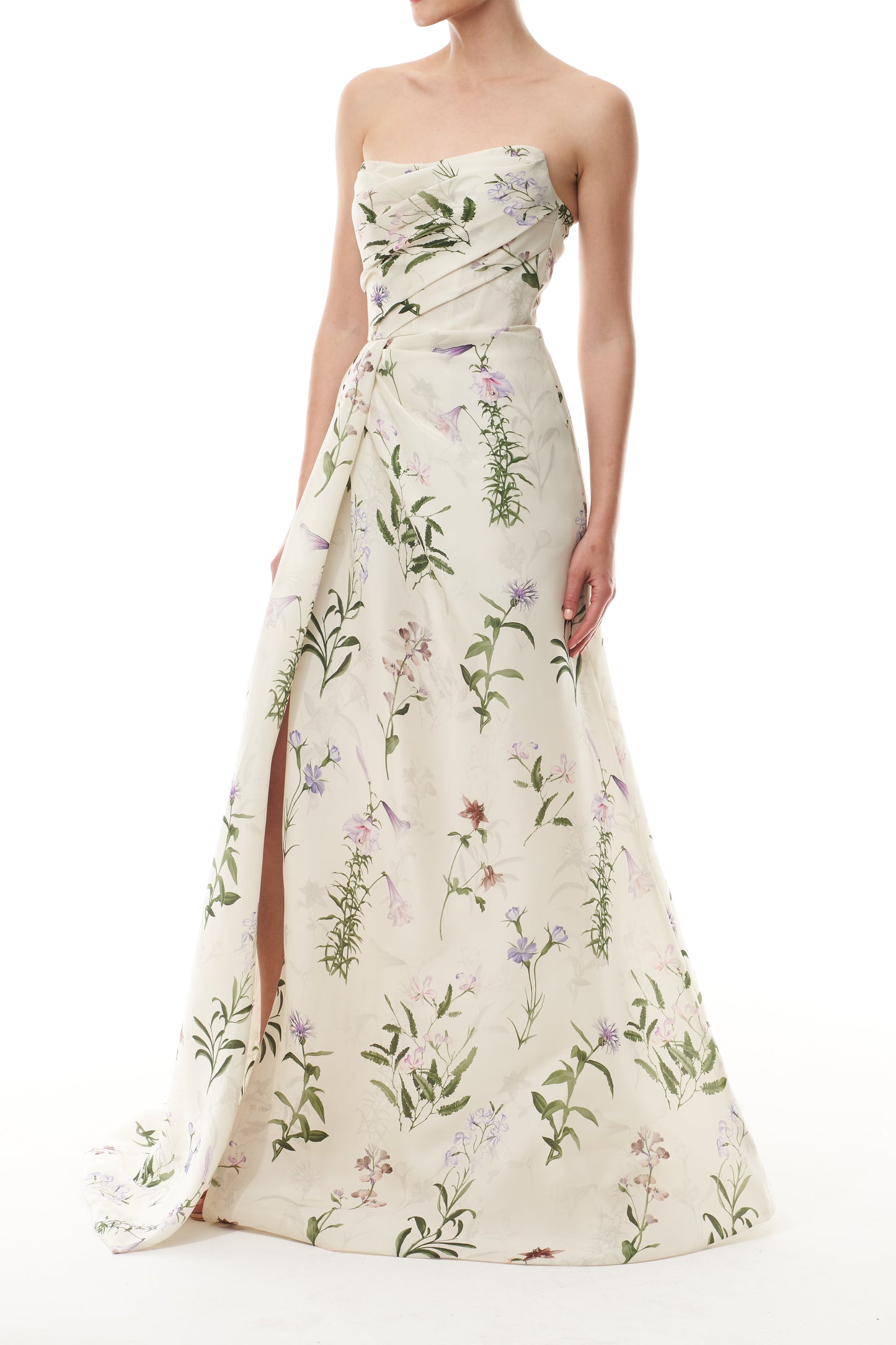 Monique Lhuillier Fall 2025 strapless, floor length gown with draped bodice and high leg slit in ivory floral multi printed gazar fabric - side.