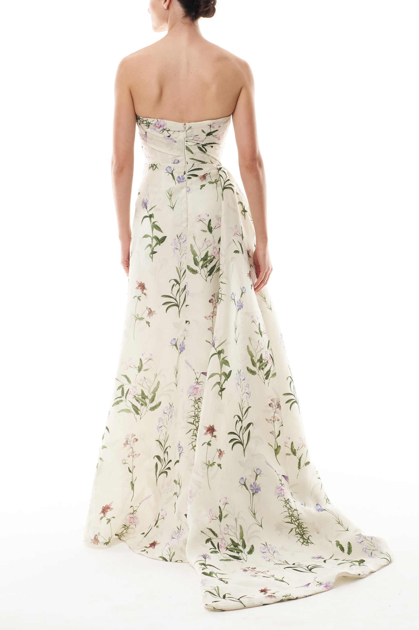Monique Lhuillier Fall 2025 strapless, floor length gown with draped bodice and high leg slit in ivory floral multi printed gazar fabric - back.