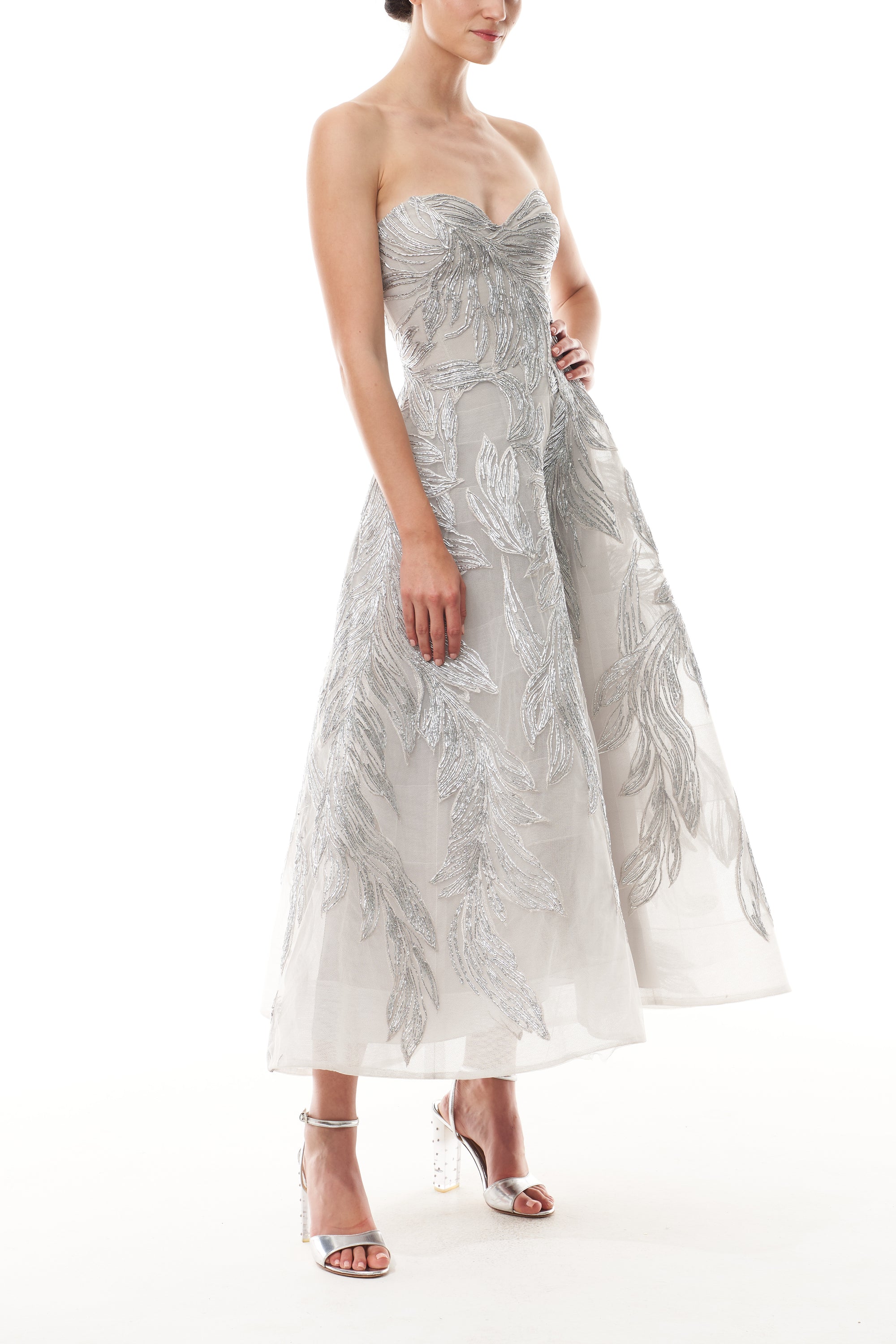 Monique Lhuillier Fall 2025 strapless dress with tea-length skirt and sweetheart neckline in silver feather embroidery - side.