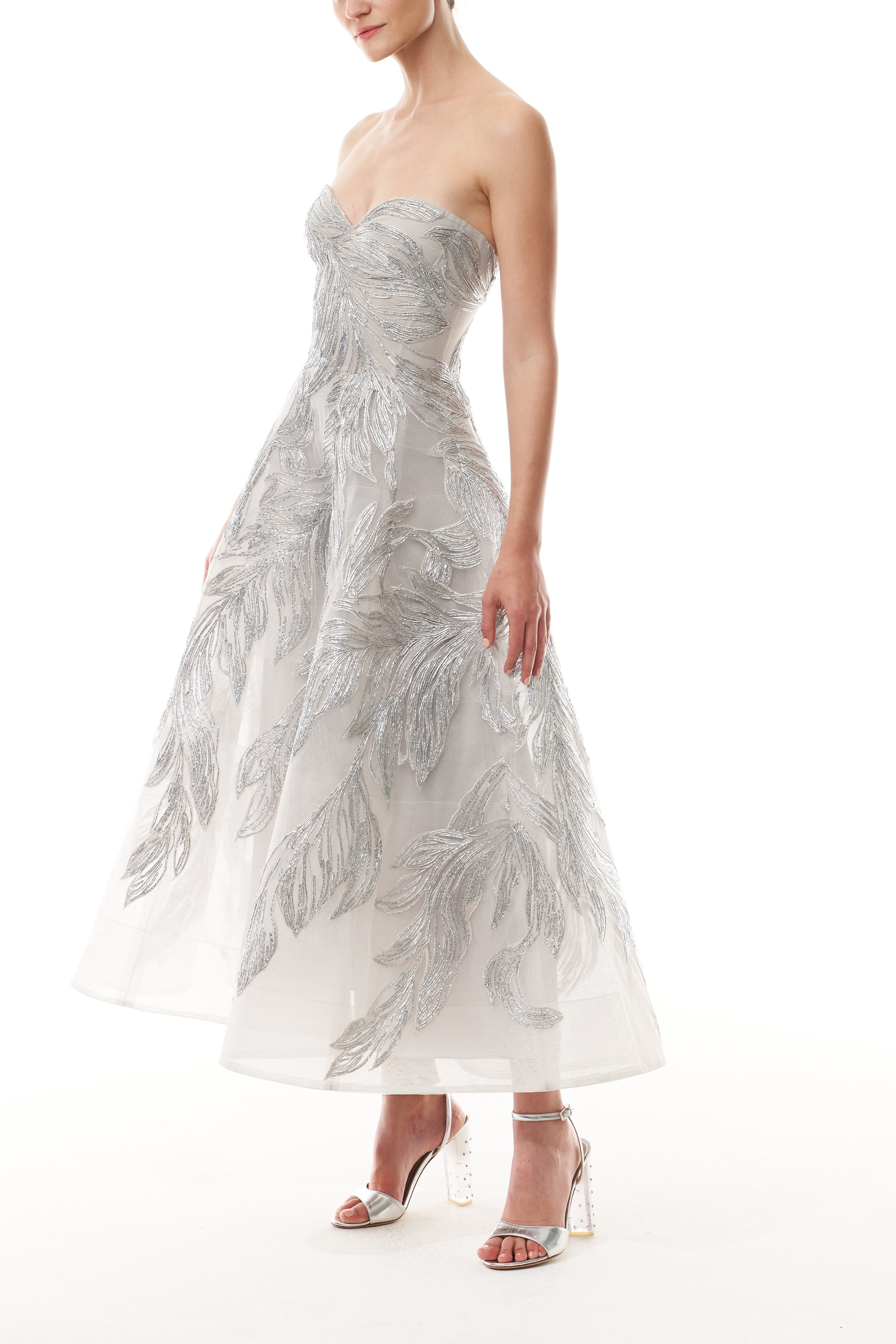 Monique Lhuillier Fall 2025 strapless dress with tea-length skirt and sweetheart neckline in silver feather embroidery - side.