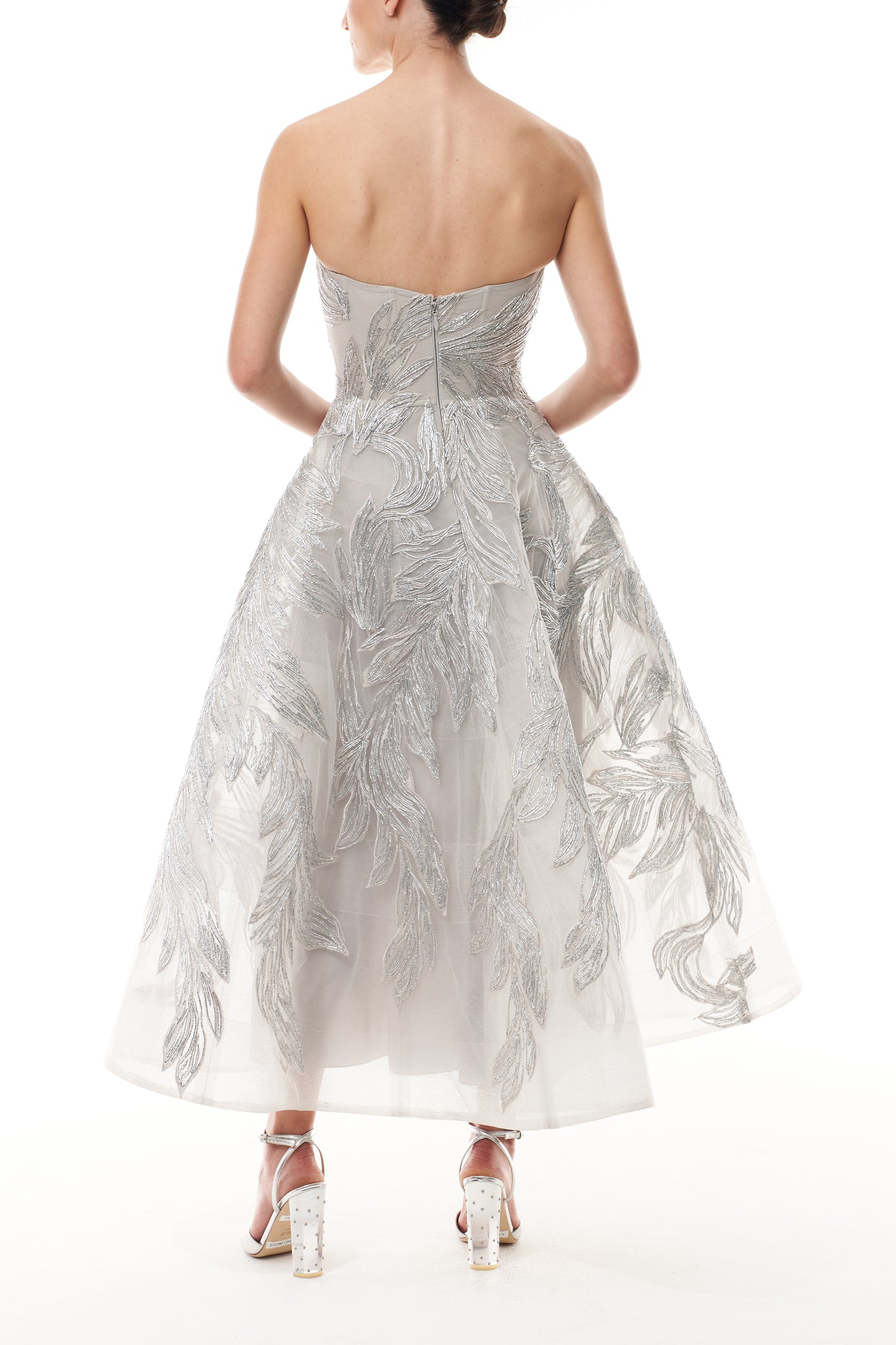 Monique Lhuillier Fall 2025 strapless dress with tea-length skirt and sweetheart neckline in silver feather embroidery - back.