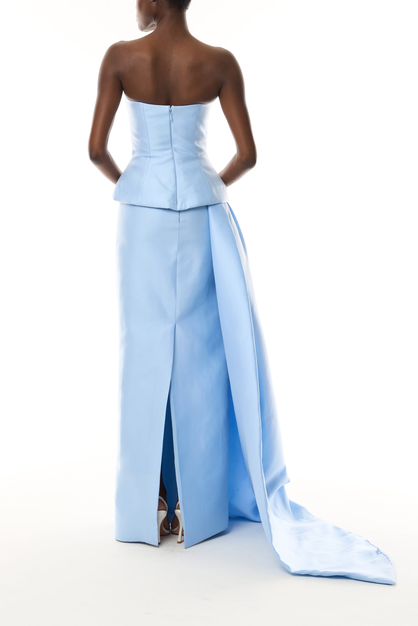 Monique Lhuillier Fall 2026 Pale Blue Mikado Piqué strapless dropped waist peplum gown with column skirt, side train and silver floral embellishment - back.
