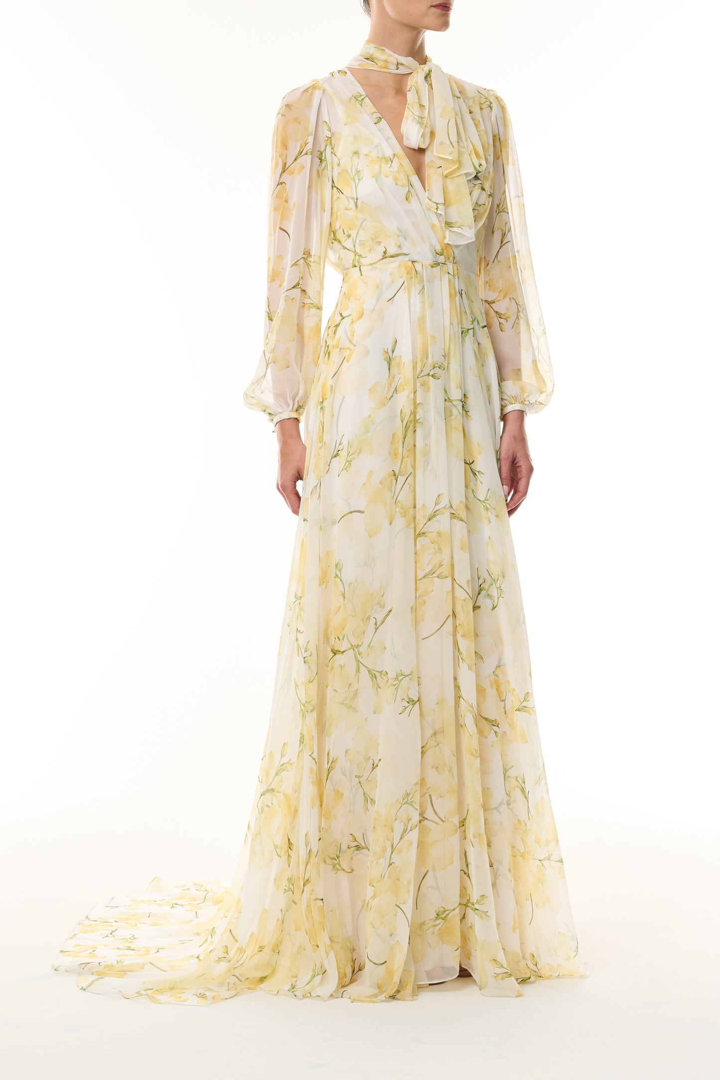 Monique Lhuillier Fall 2026 Pale Yellow/Multi Snapdragon Floral Printed Chiffon Draped V-neck long sleeve gown with blouson sleeves - front.