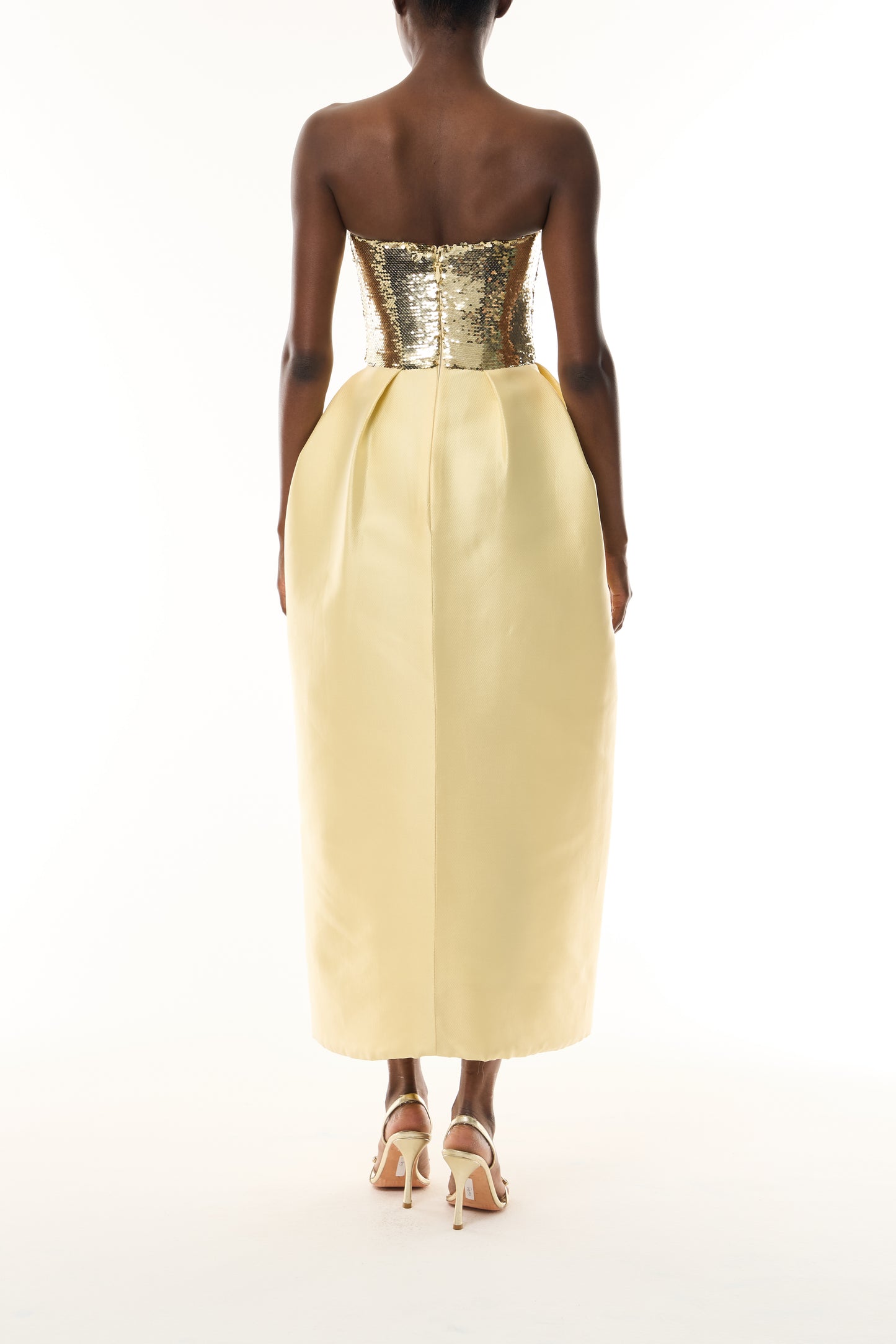 Monique Lhuillier Fall 2026 strapless midi dress with Gold sequin bodice and Pale yellow tulip cut Mikado Piqué skirt - back.