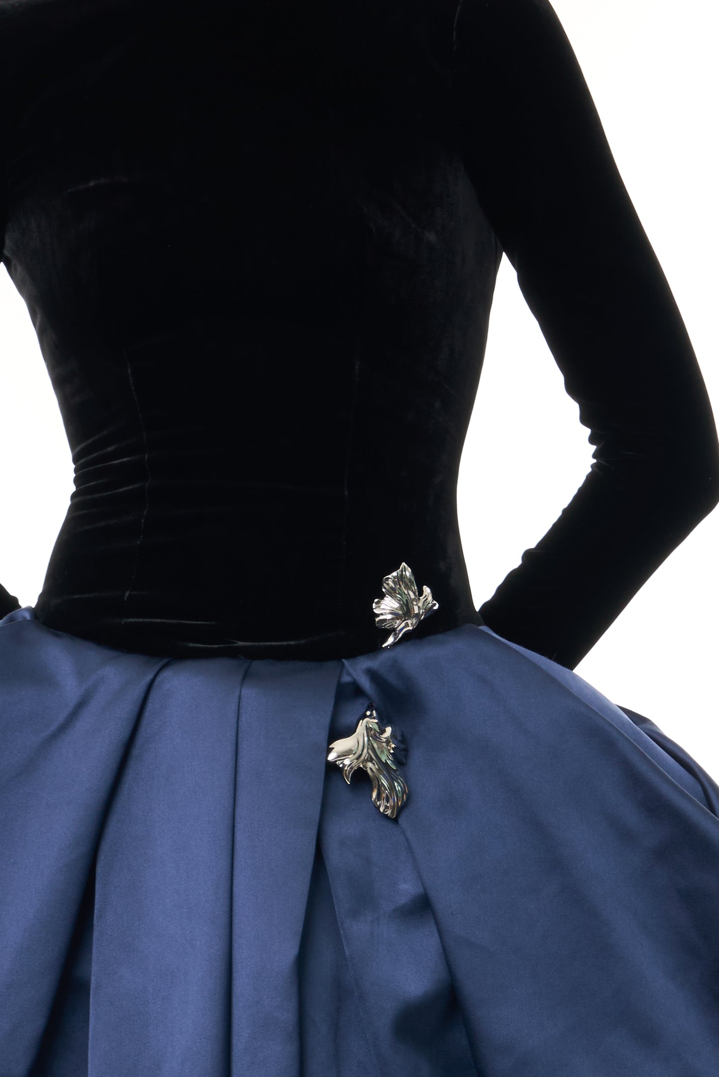 Monique Lhuillier Fall 2026 Noir and Navy Velvet and Duchess Satin long sleeve high neck pleated ballgown with silver floral embellishment - fabric.
