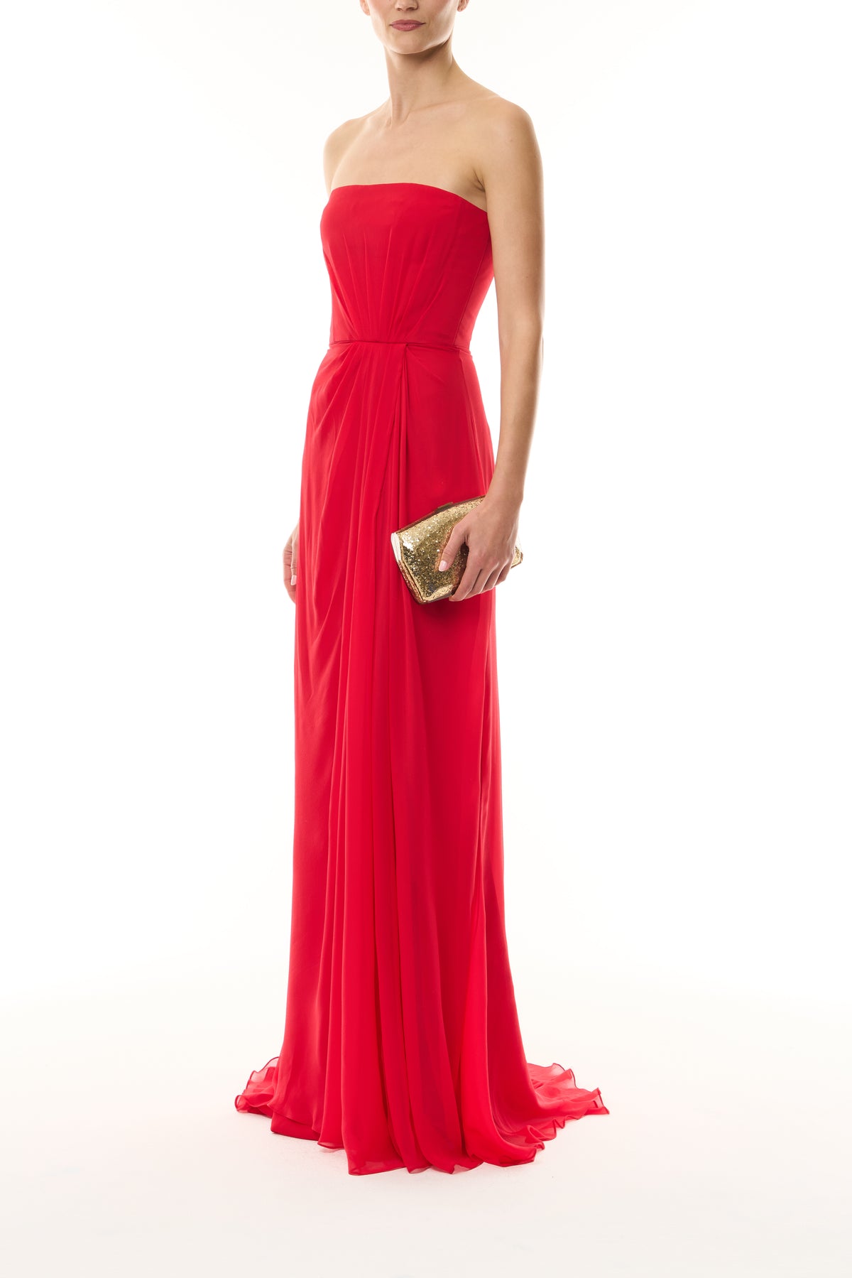 Monique Lhuillier Fall 2026 Siren red Chiffon strapless draped bodice gown - side with Gold Dasha Minaudiere.