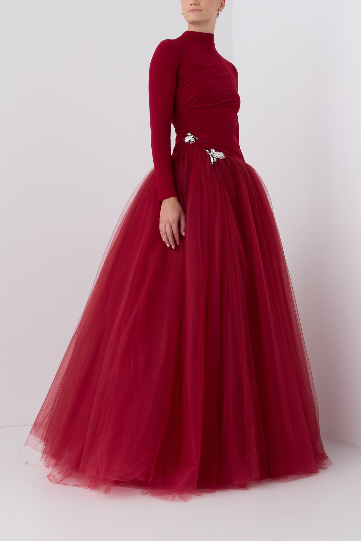 Monique Lhuillier Fall 2026 Rhubarb crepe jersey and tulle Long sleeve dropped waist floor-length gown with floral embellishment - side.