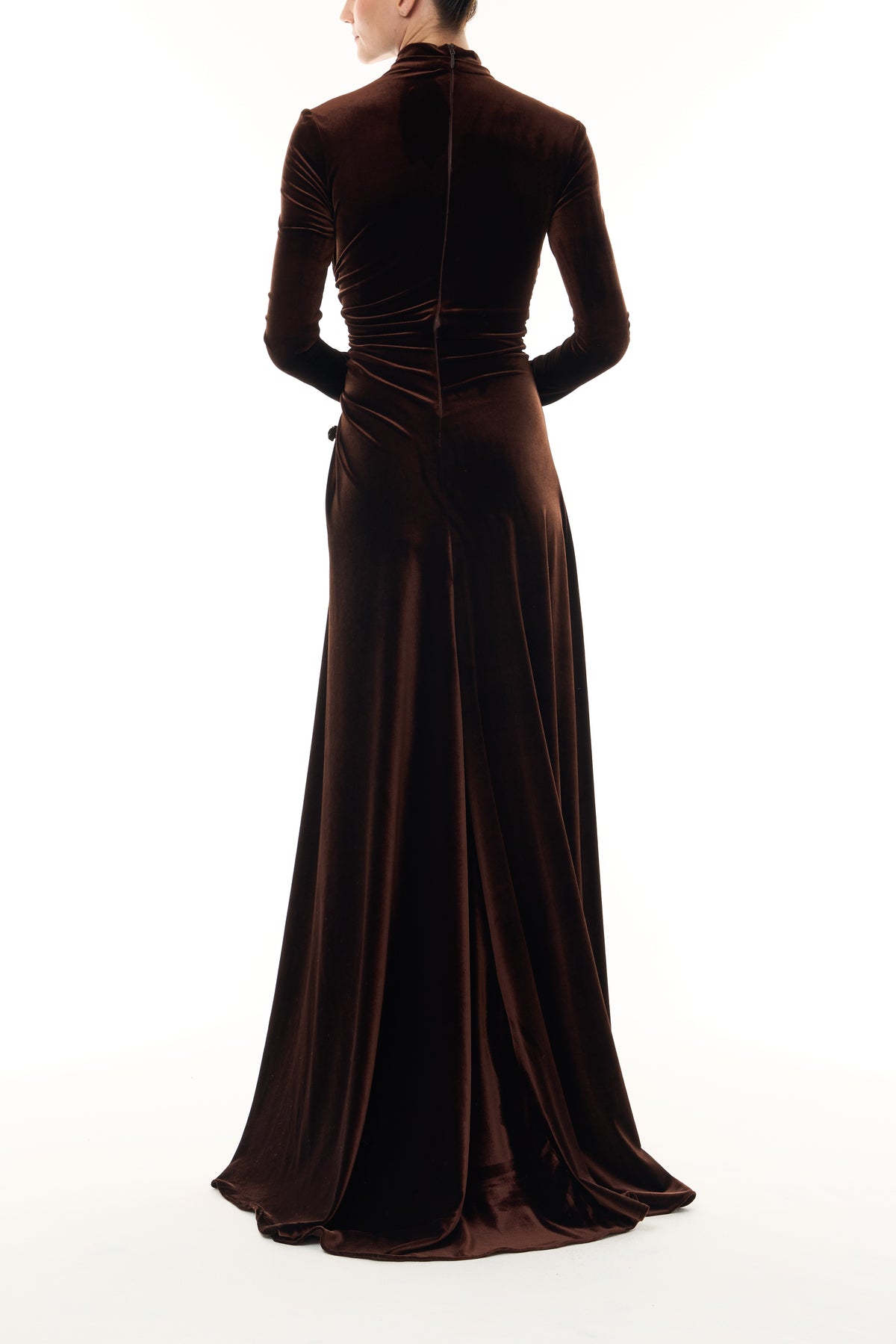 Monique Lhuillier Fall 2026 Café brown stretch velour high neck long sleeve gown with slit and gold floral embellishment -back.