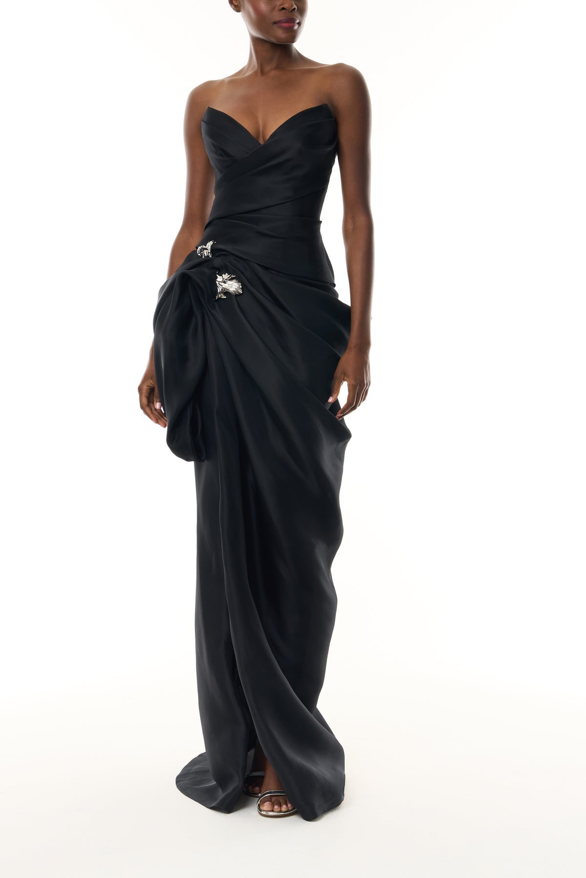 Monique Lhuillier Fall 2026 Noir Gazar strapless draped gown with sculpted skirt and silver floral embellishment - front.
