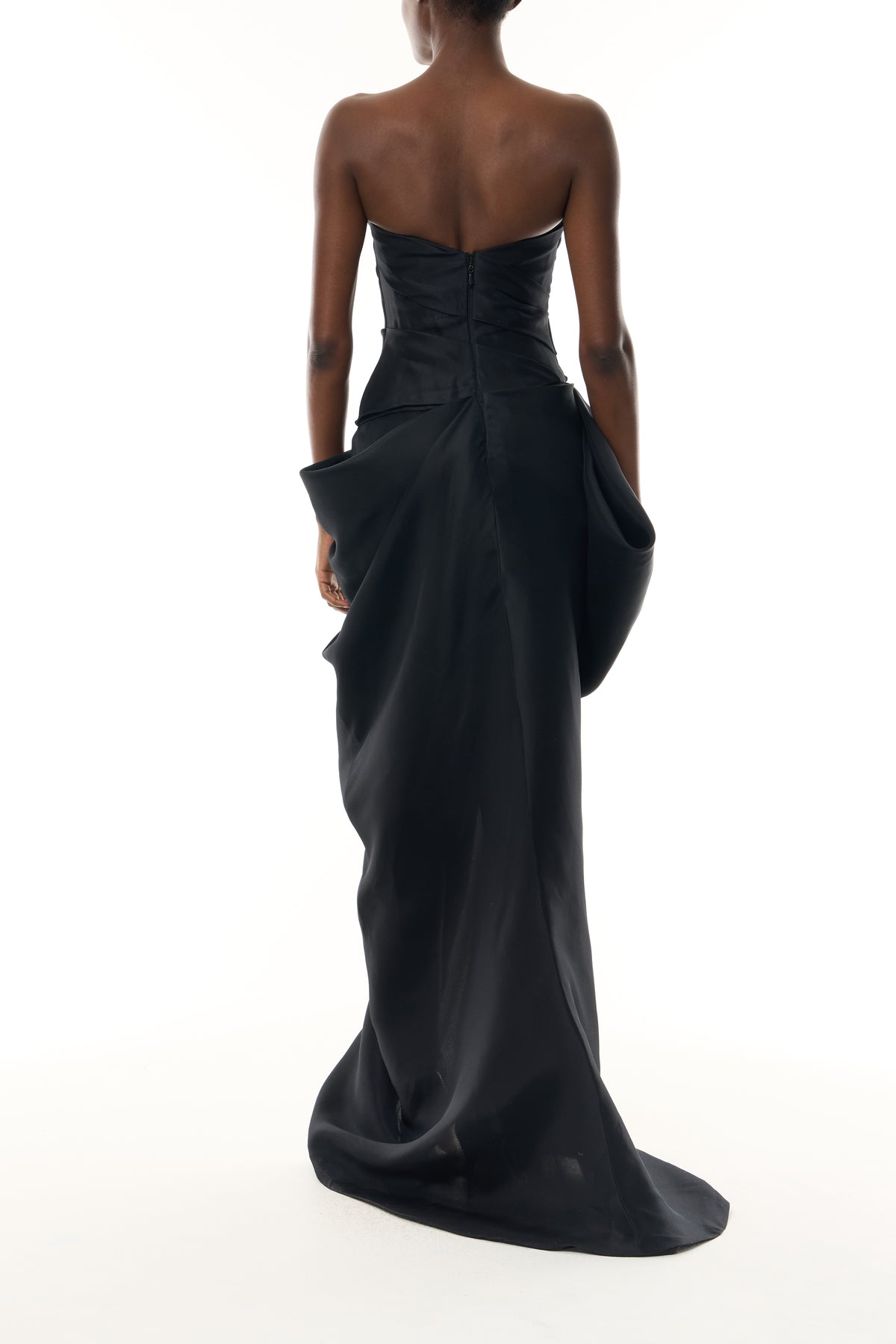 Monique Lhuillier Fall 2026 Noir Gazar strapless draped gown with sculpted skirt and silver floral embellishment - back.