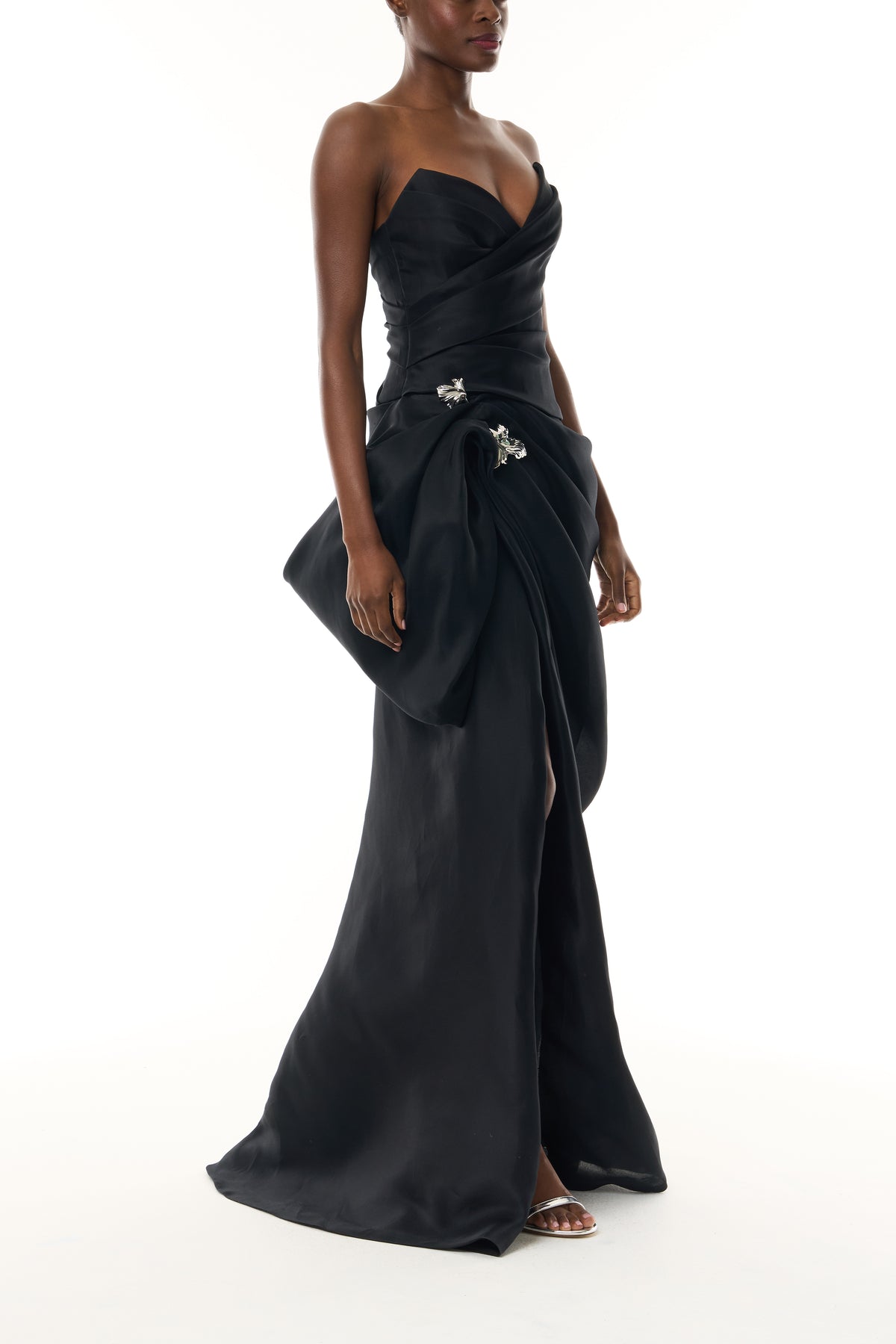 Monique Lhuillier Fall 2026 Noir Gazar strapless draped gown with sculpted skirt and silver floral embellishment - side.