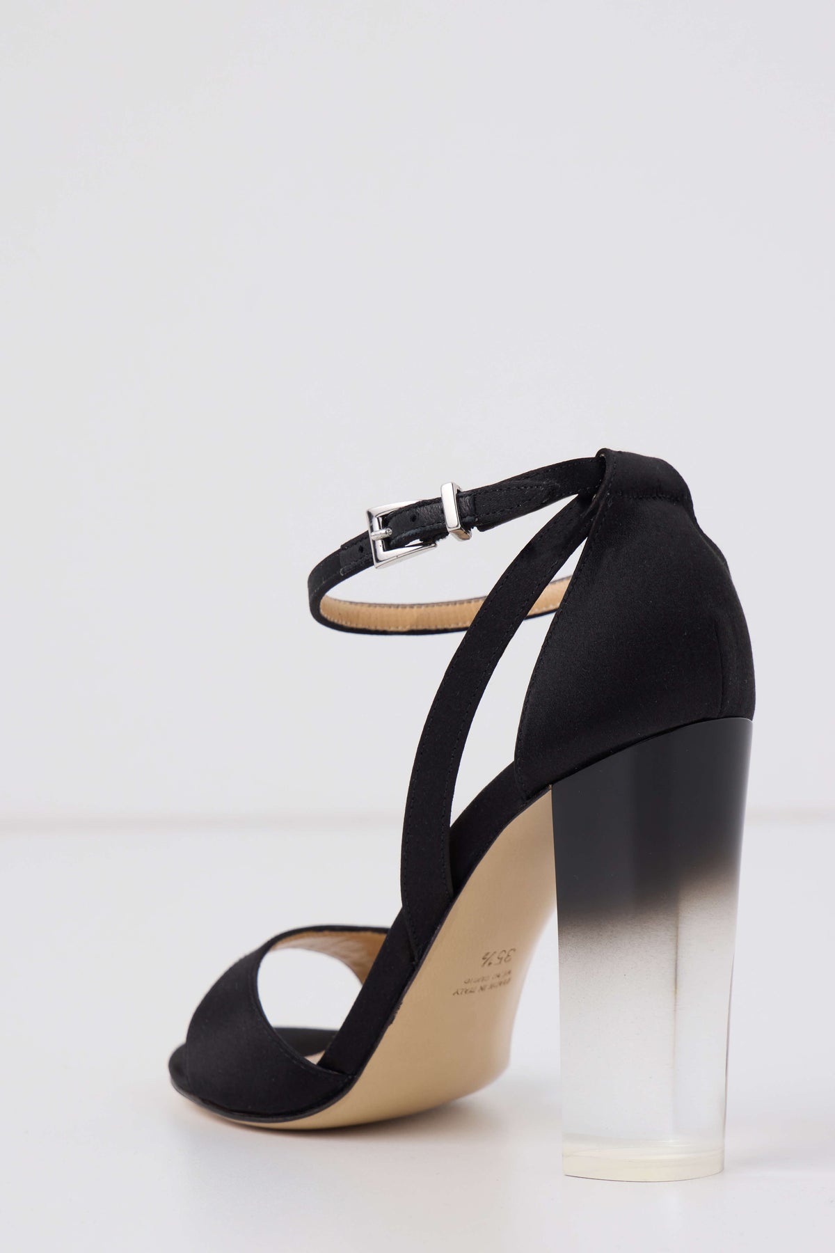 Ava sandal in Noir satin with silver buckle ankle strap and ombre lucite heel - back angle.